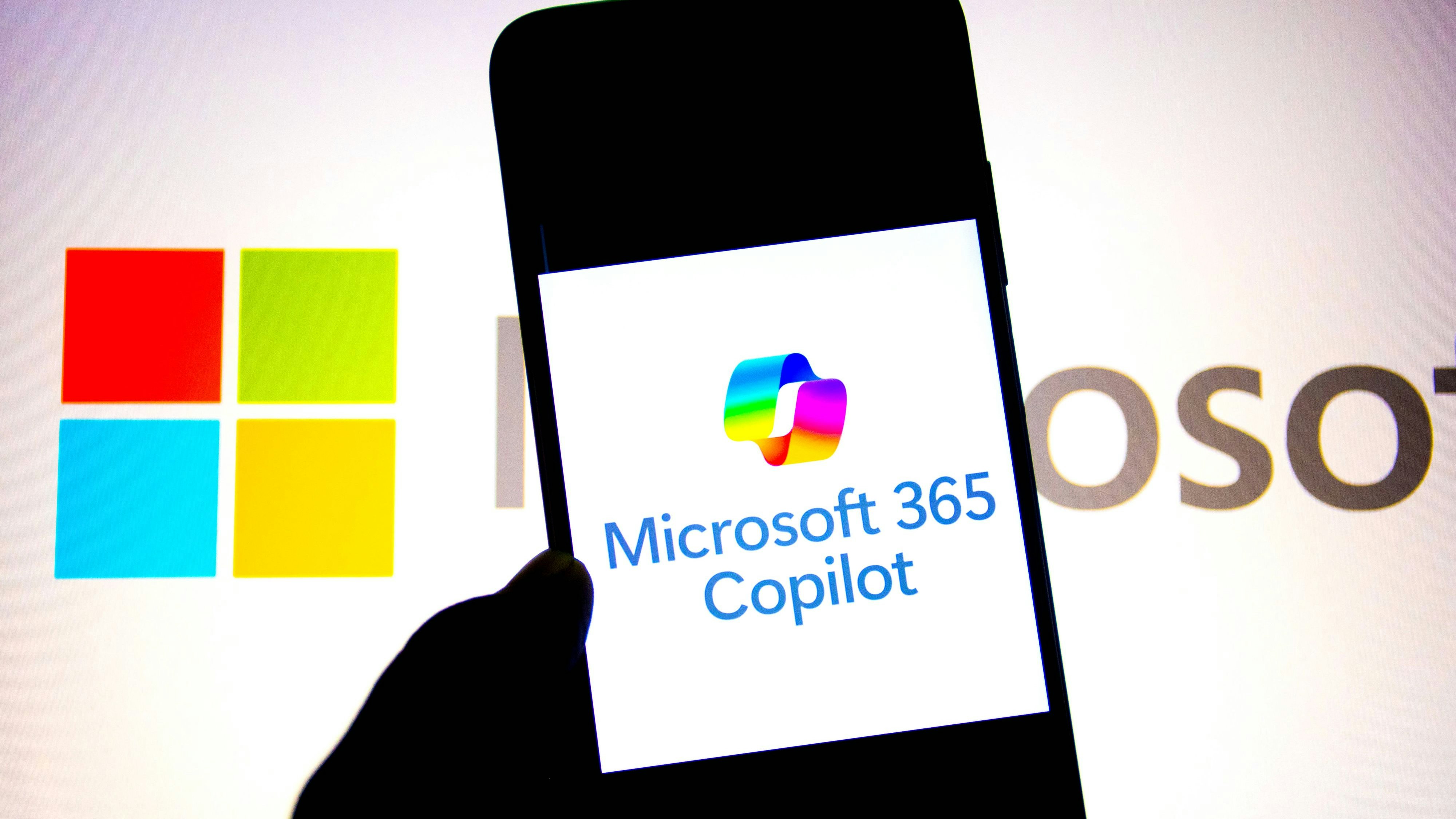 Photo illustration in India - 19 Sept 2024 In this photo illustration, a Microsoft 365 Copilot logo seen displayed on a smartphone with a Microsoft Logo in the background. India Copyright: xAvishekxDasx/xSOPAxImagesx avdsept24anklot10i