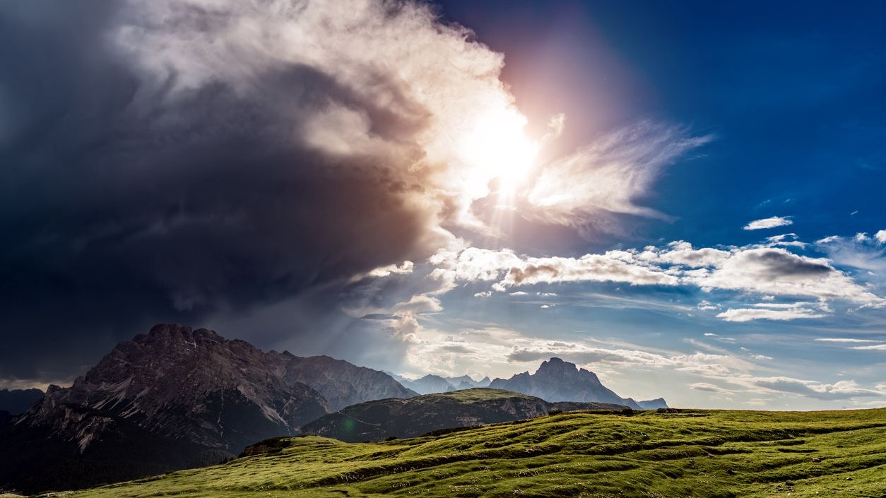 A storm cloud is coming in the sun. The beginning of the storm. National Nature Park Tre Cime In the Dolomites Alps. Beautiful nature of Italy.