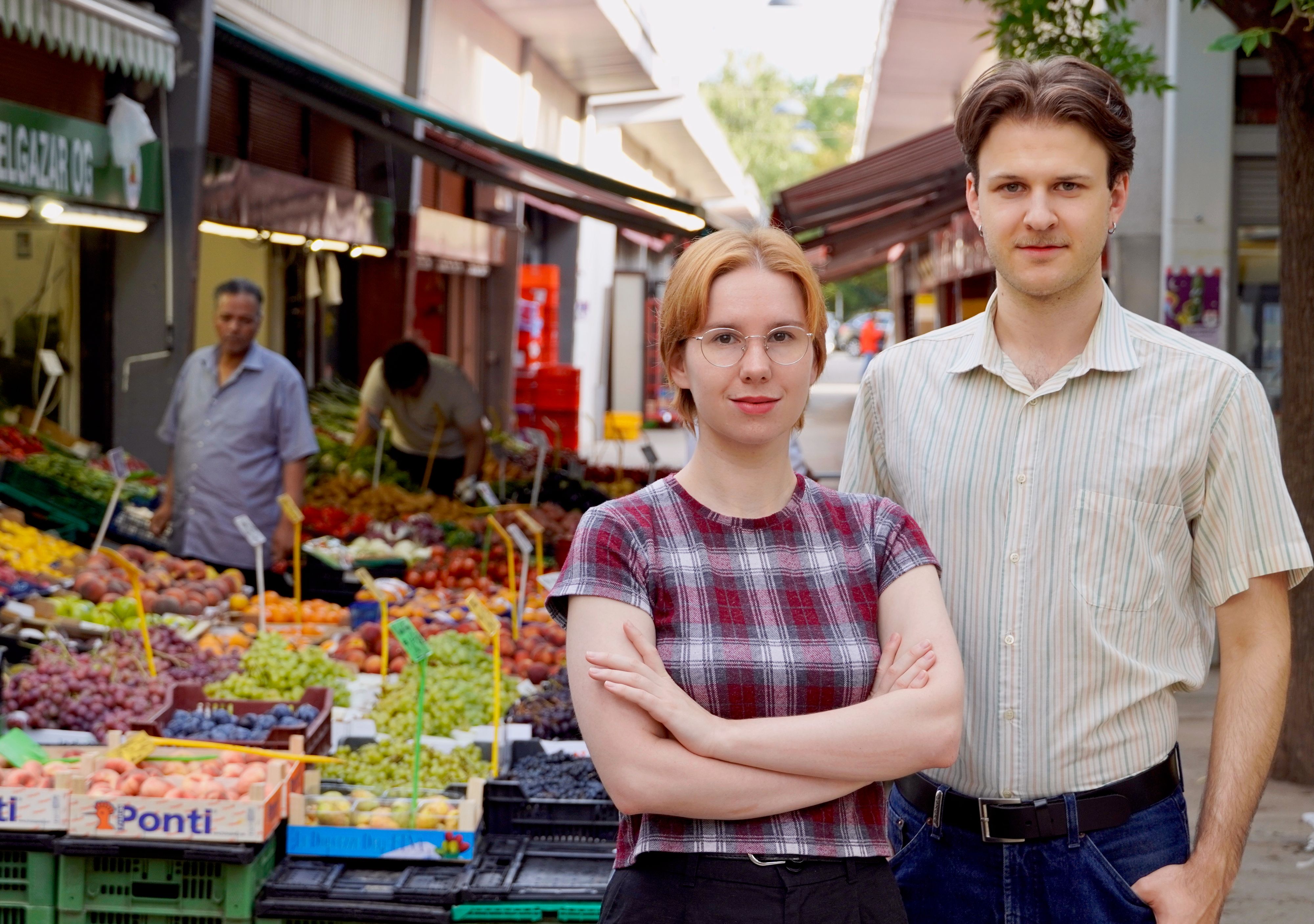 Die Bezirksräte der KPÖ Brigittenau Nathalie Burkowski und Matthias Kaltenböck stellen sich schützend vor den Hannovermarkt.