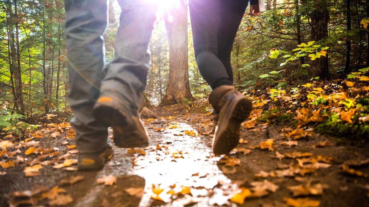Young couple hiking in mountain on a footpath in Canada