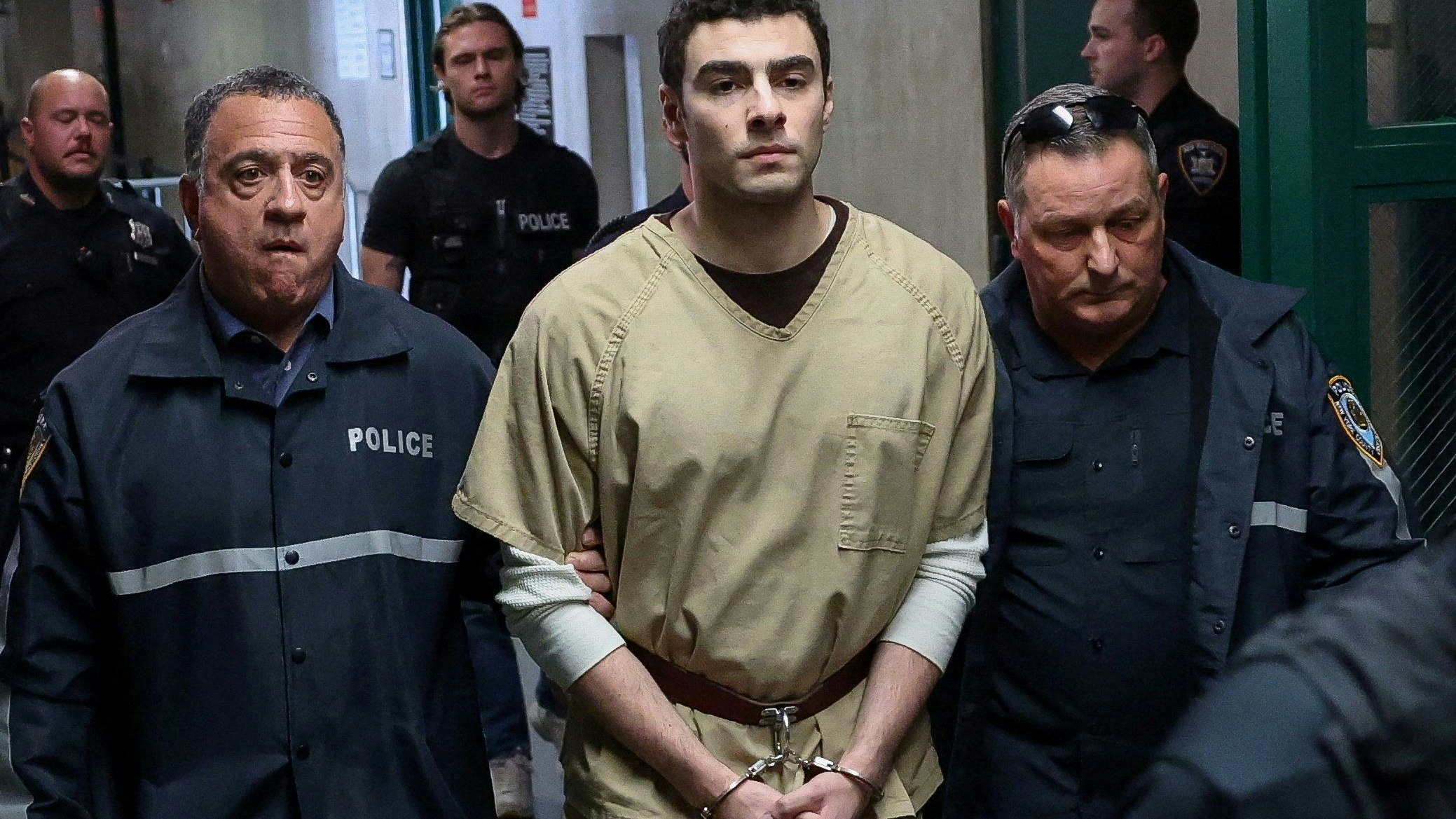 Luigi Mangione, the suspect in the killing of UnitedHealthcare chief executive Brian Thompson, is escorted by police officers at Manhattan Supreme Court on the day he appears on New York State murder and terrorism charges, in New York City, U.S., September 16, 2025. REUTERS/Mike Segar     TPX IMAGES OF THE DAY     