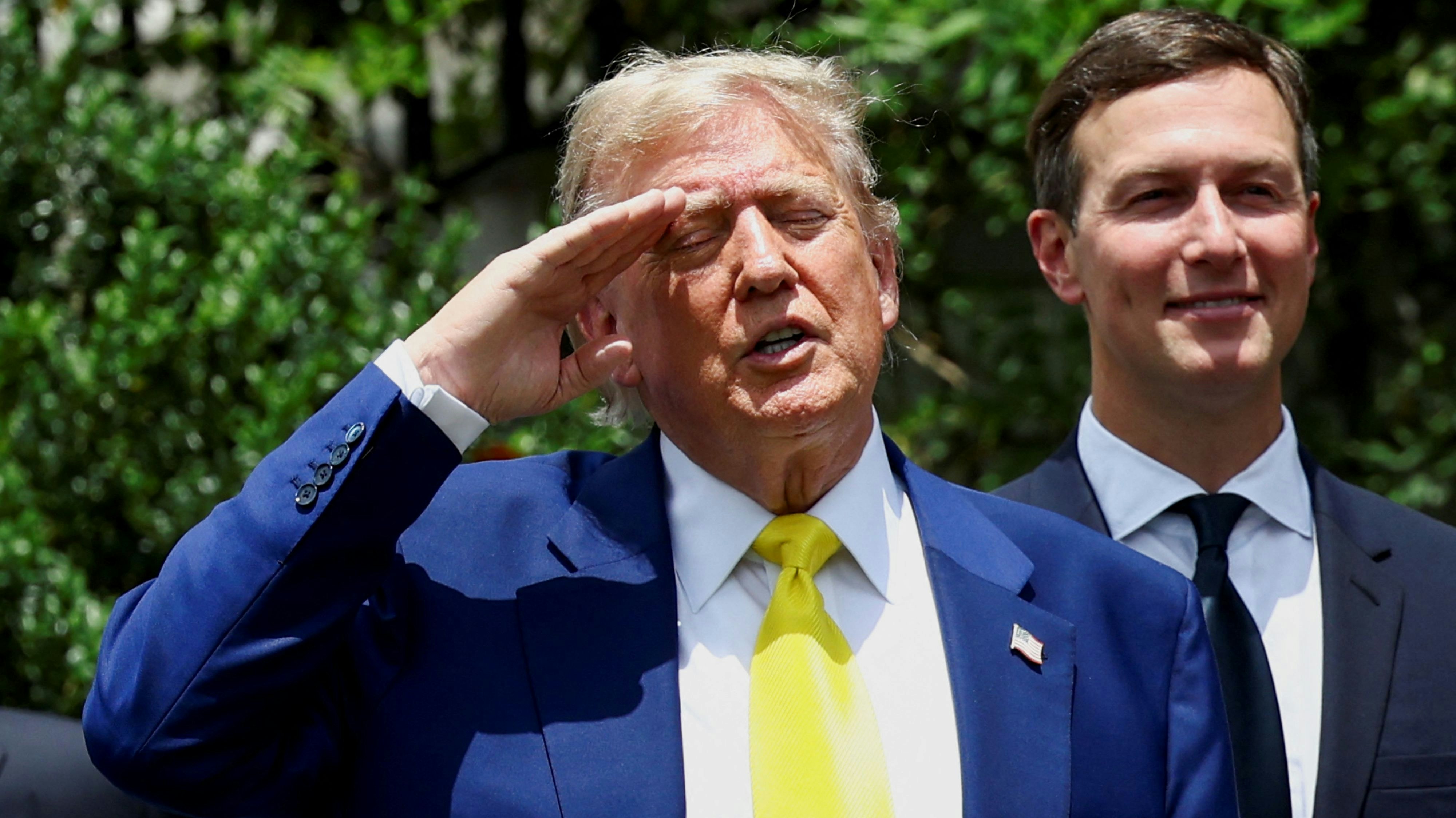 U.S. President Donald Trump, next to Ivanka Trump's husband Jared Kushner, salutes as a U.S. flag is raised on a new flagpole installed on the South Lawn of the White House in Washington, D.C., U.S. June 18, 2025.  REUTERS/Kevin Lamarque