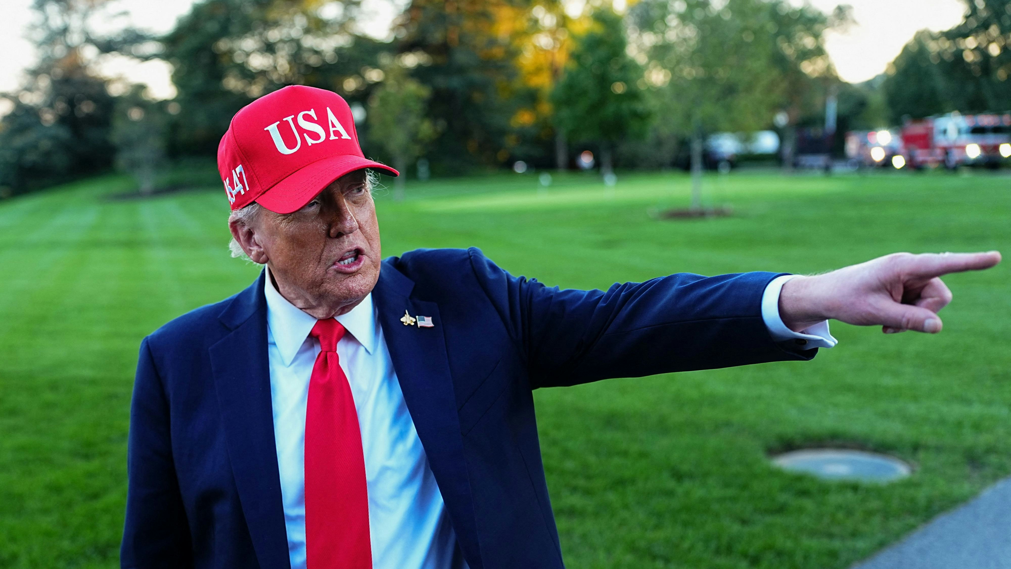 U.S. President Donald Trump points a finger as he speaks to members of the media upon his arrival at the White House in Washington, D.C., U.S., October 5, 2025. REUTERS/Aaron Schwartz 