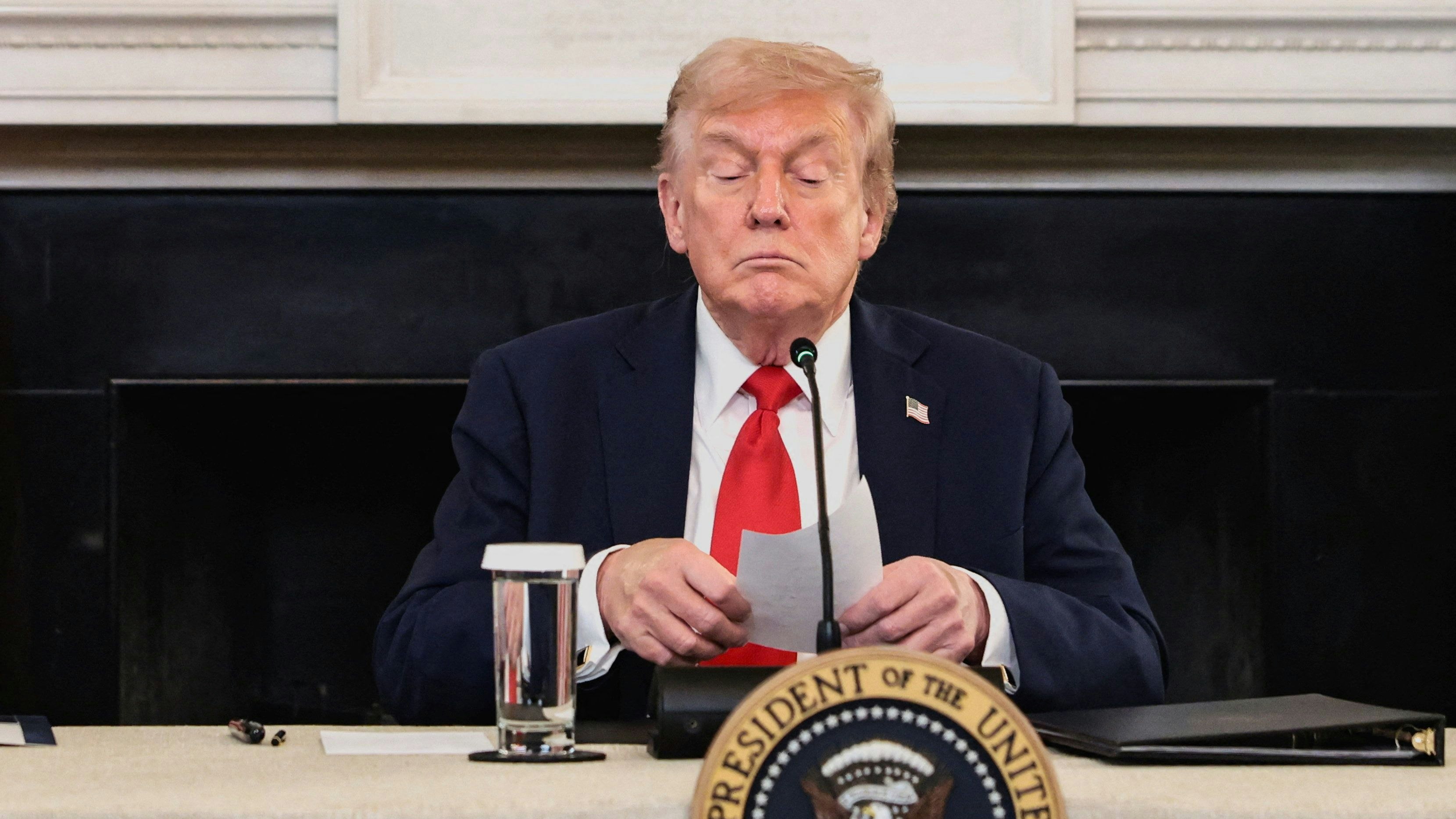 U.S. President Donald Trump holds a note that was handed to him by U.S. Secretary of State Marco Rubio during a roundtable on antifa, an anti-fascist movement Trump designated a domestic "terrorist organization" via executive order on September 22, at the White House in Washington, D.C., U.S., October 8, 2025. REUTERS/Evelyn Hockstein     TPX IMAGES OF THE DAY     