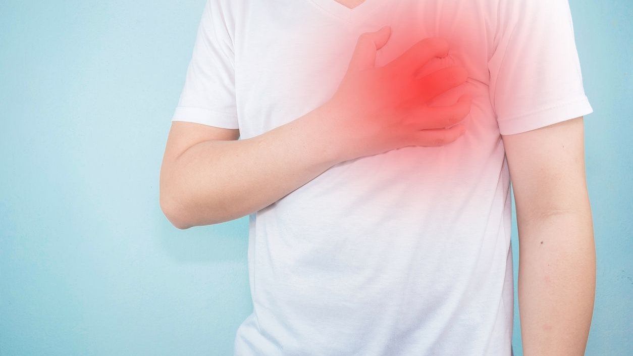 Asian men use hands to hold their hearts. Showing pain from heart disease,Heart attack symptom Healthcare and medical concept