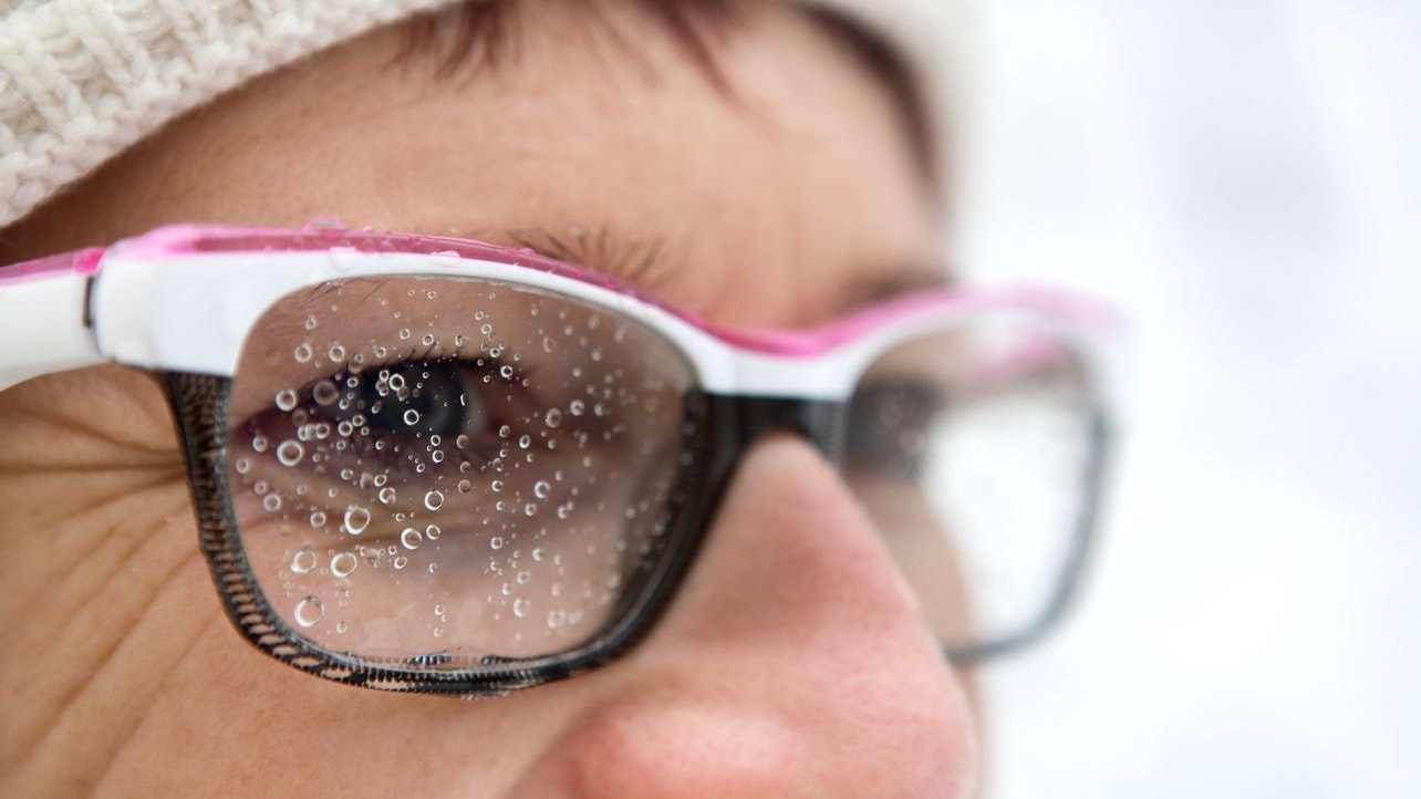 female face with glasses and raindrops