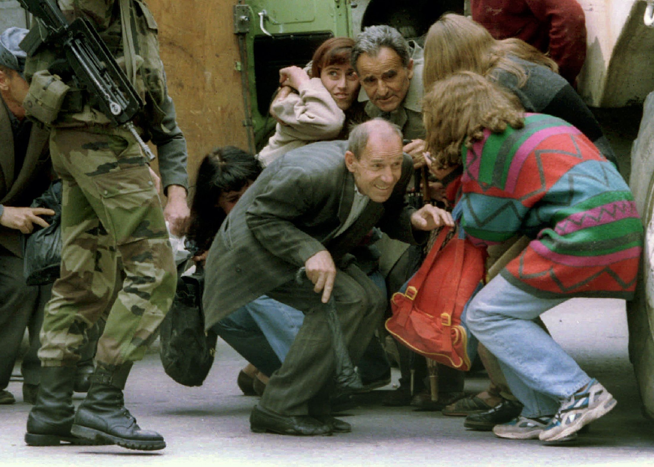 Sarajevo, 7. Juni 1995: Insaßen eines Autos, das in Sarajevo unter Scharfschützenbeschuss geriet, suchen hinter einem französischen Schützenpanzer Deckung.