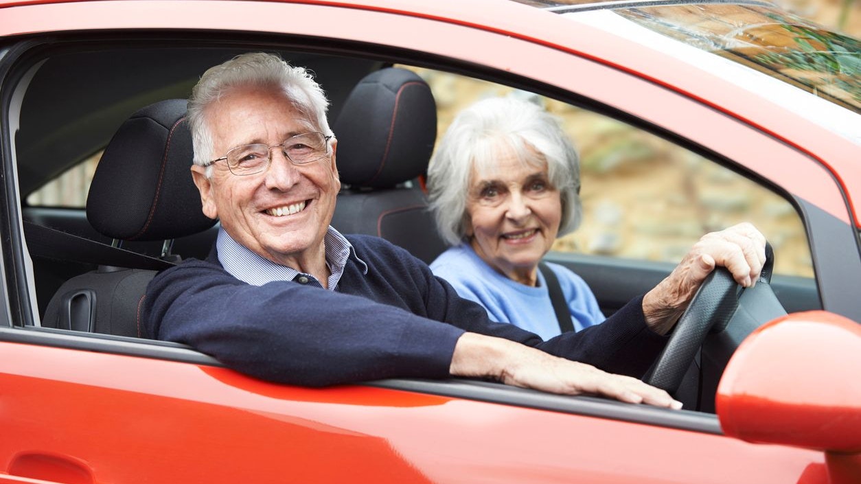 Portrait Of Smiling Senior Couple Out For Drive In Car