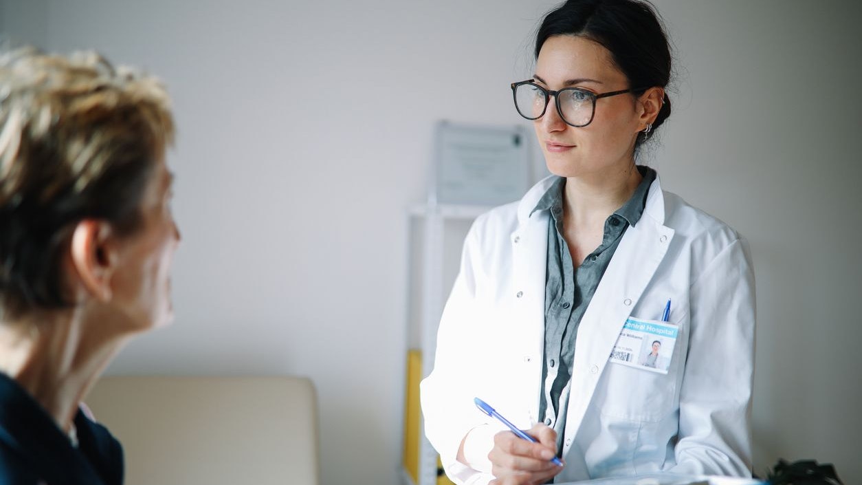 Senior woman talking to the doctor in the office.