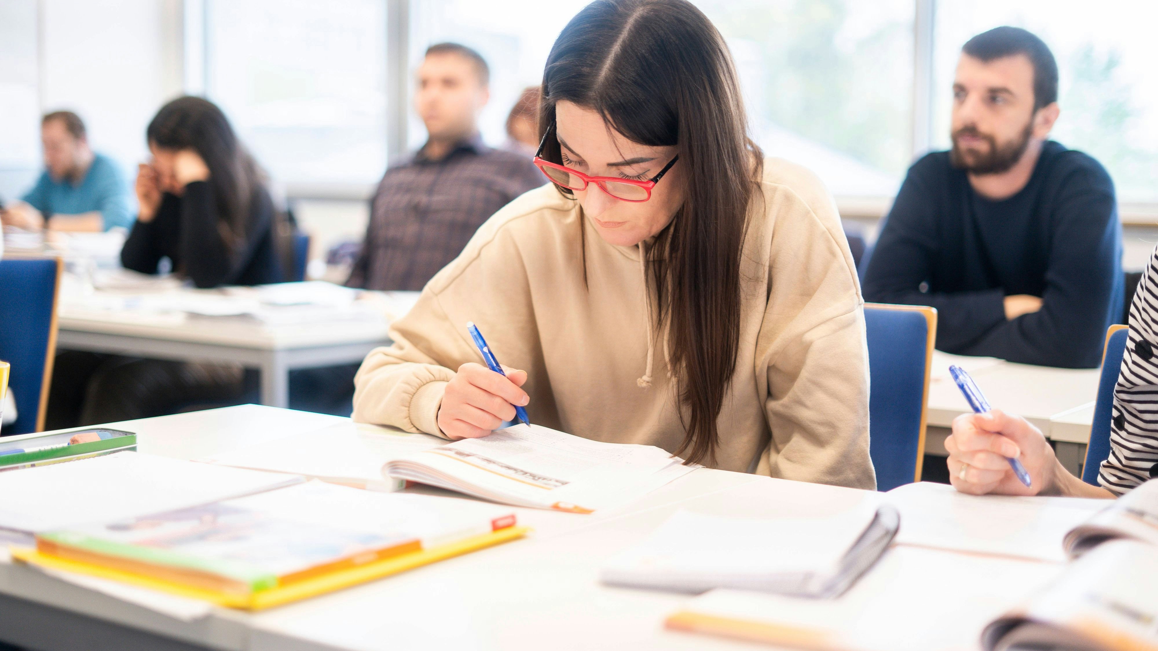Female student with red glasses studying in a language course classroom model released, Symbolfoto property released, NJAF01655
