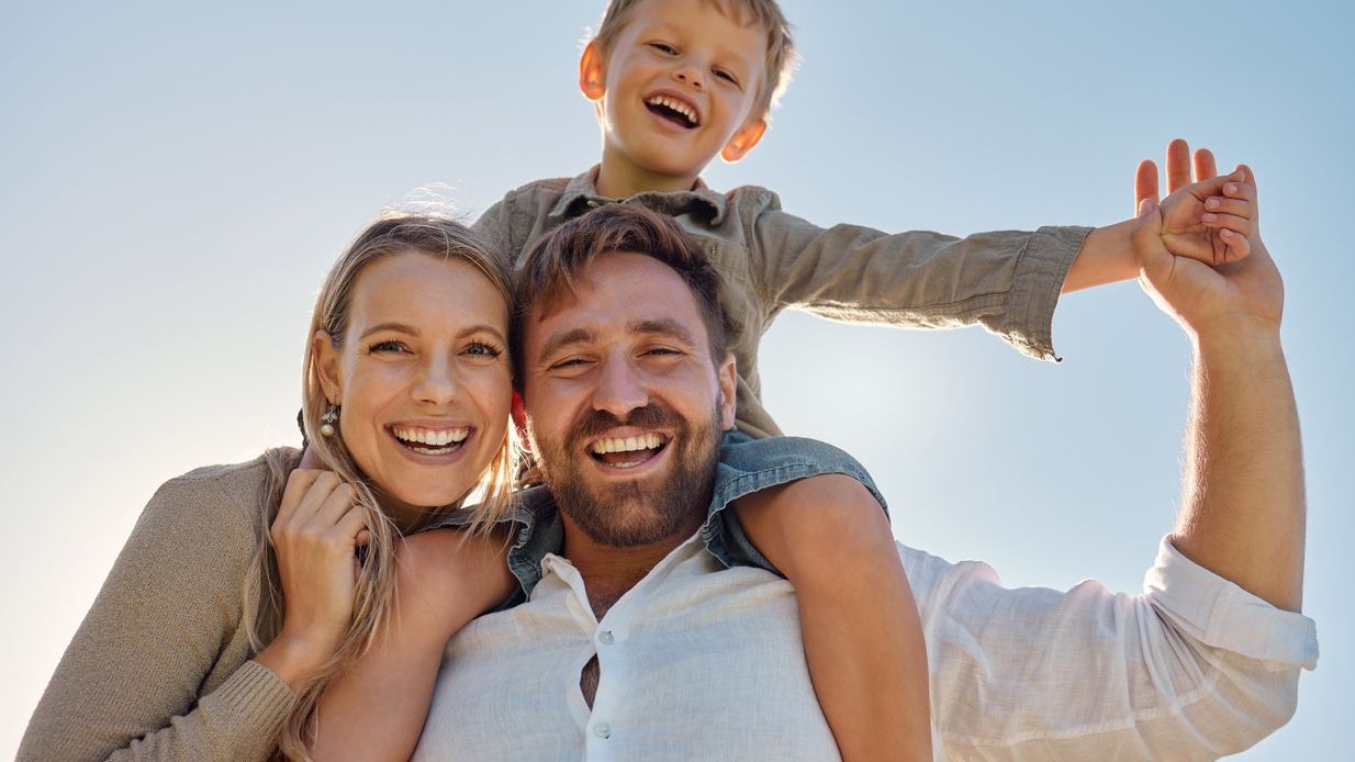 Family, mother and father with child, for holiday, vacation and being happy together outdoor. Portrait, mama and dad with kid for quality time, travel and bonding being loving, carry boy and have fun