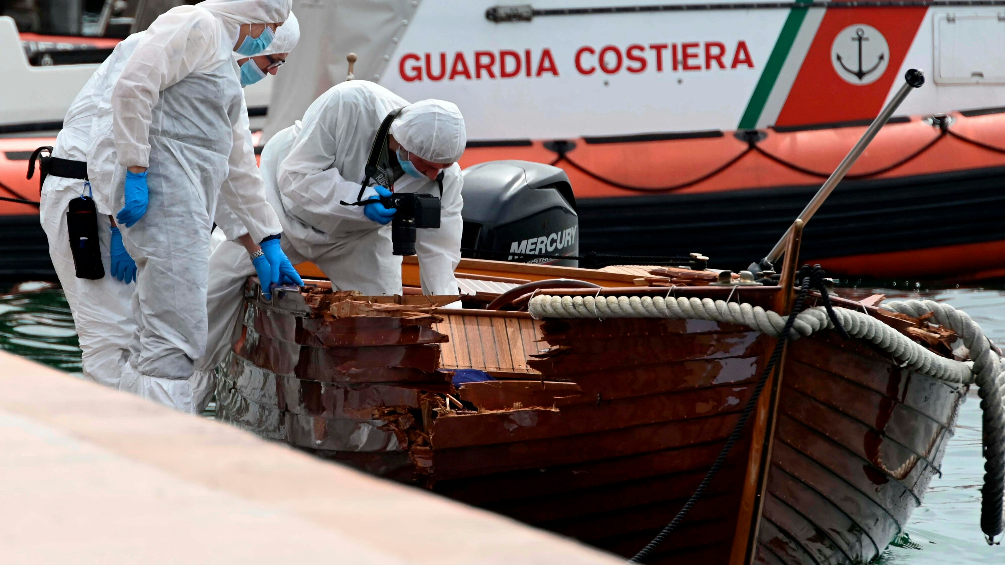 FILE - In this June 21, 2021 file photo, Italian forensic police inspect the damage on a boat as they investigate two German tourists from Munich for a boat collision which killed an Italian man and woman, in Salo', on Lake Garda, northern Italy. Italian authorities say a German man has returned to Italy to surrender himself to police in the criminal probe of a boating accident that killed two Italian boaters last month on Lake Garda. Brescia Prosecutor Francesco Prete told state TV on Monday that besides being investigated for two counts of manslaughter, the suspect is also jailed for failure to help the stricken boaters. (AP Photo/Gabriele Strada, File)