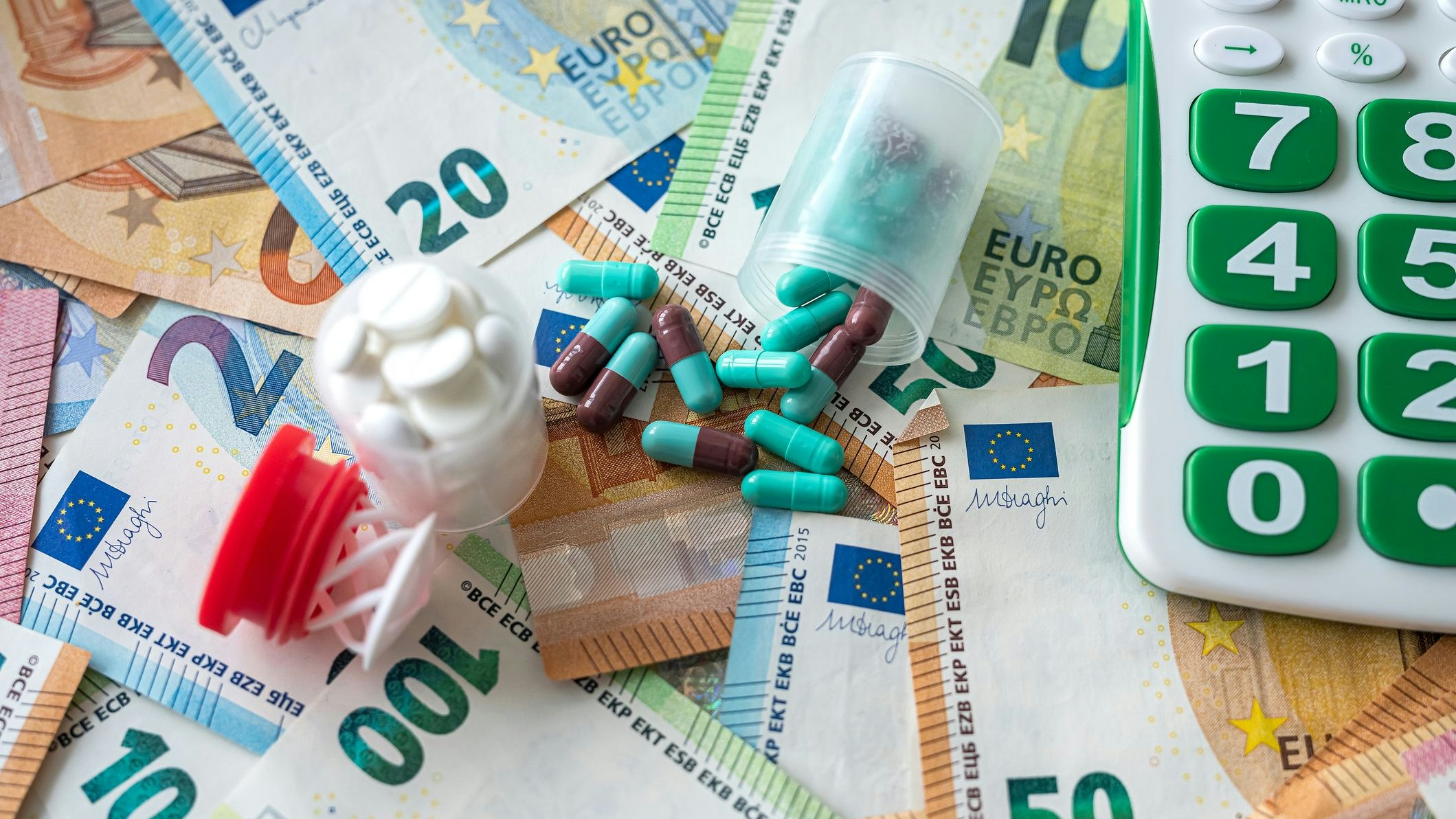 business calculator pharmacy pills and euro banknotes. medical concept