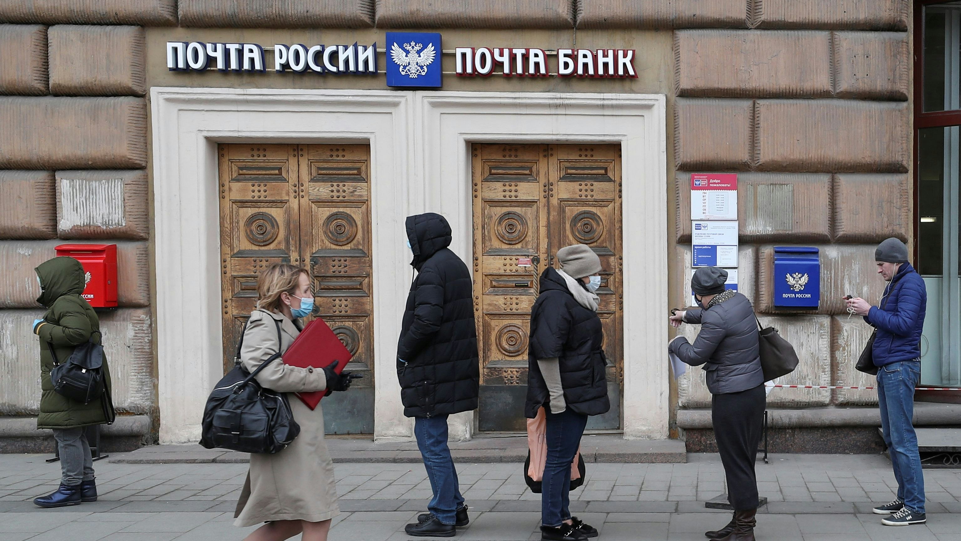 People queue outside an office of Russian Post, after the city authorities announced a partial lockdown ordering residents to stay at home to prevent the spread of coronavirus disease (COVID-19), in Moscow, Russia March 30, 2020. REUTERS/Evgenia Novozhenina