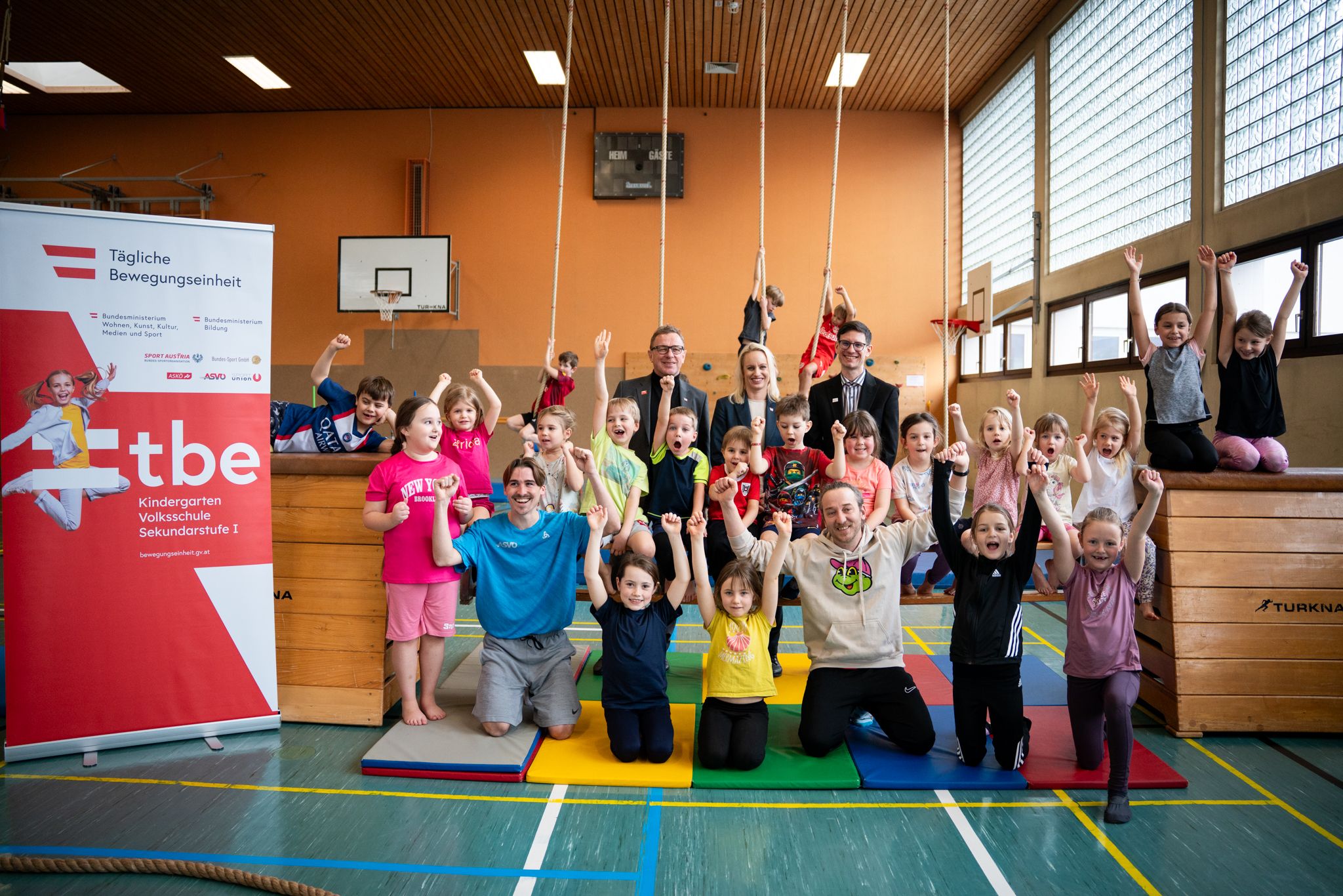 Teamchef Ralf Rangnick und Sport-Staatssekretärin Michaela Schmidt bei einer Trainingseinheit mit Kids im Turnsaal.