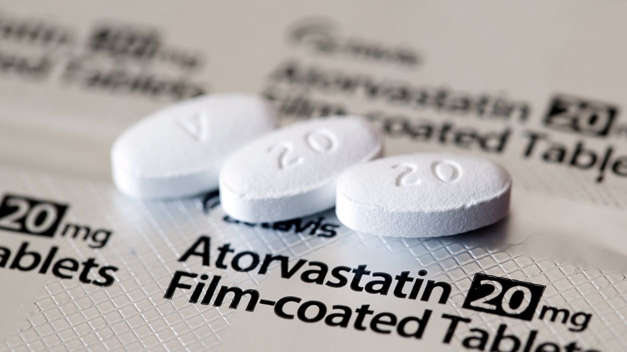 Aberdeen, Scotland - April 7, 2014: Close up view of three Atorvastatin tablets.  Atorvastatin is a member of the drug class known as statins, used for lowering blood cholesterol levels.