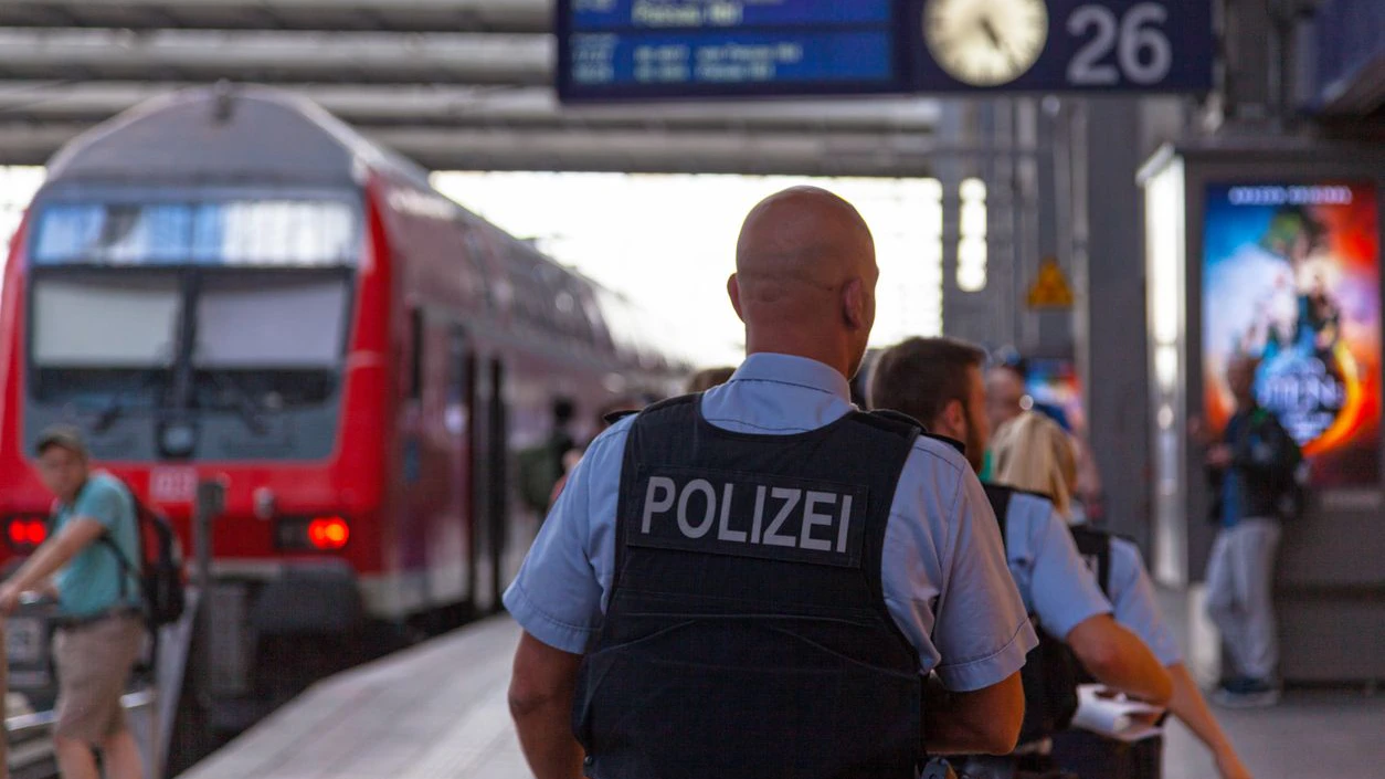 Munich, Germany - May 30 2019: Group of police officers in bulletproof vest patrolling in München Hauptbahnhof (German for Munich main railway station).