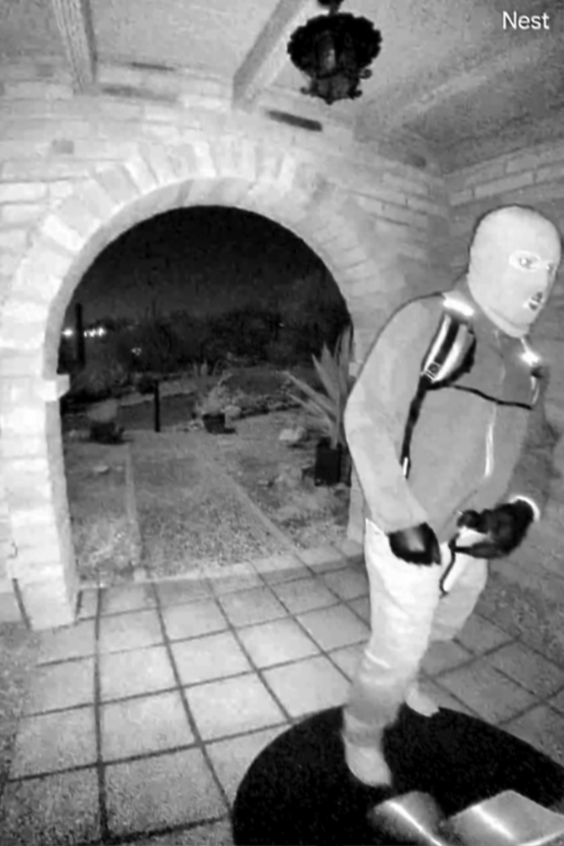 Der mutmaßliche Entführer vor der Eingangstüre zu Nancy Guthries Haus. Die Pistole trägt er an der Vorderseite seines Hosenbundes mittig