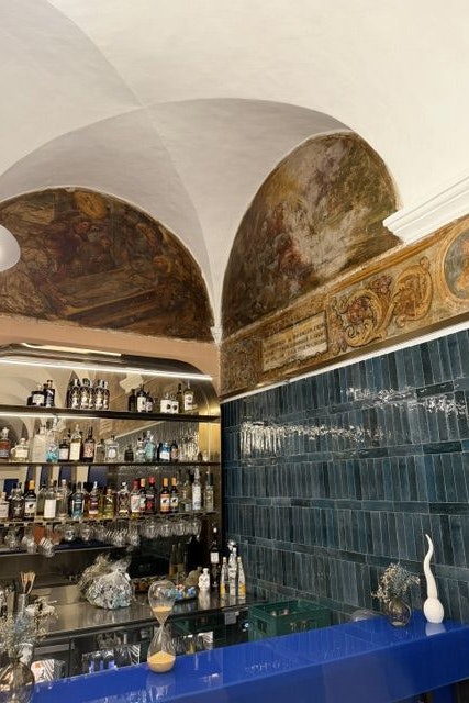 Bar in blauer Kachel, Fresken in den Bögen, als hätte jemand das Abendmahl auf Meeresdiät gesetzt