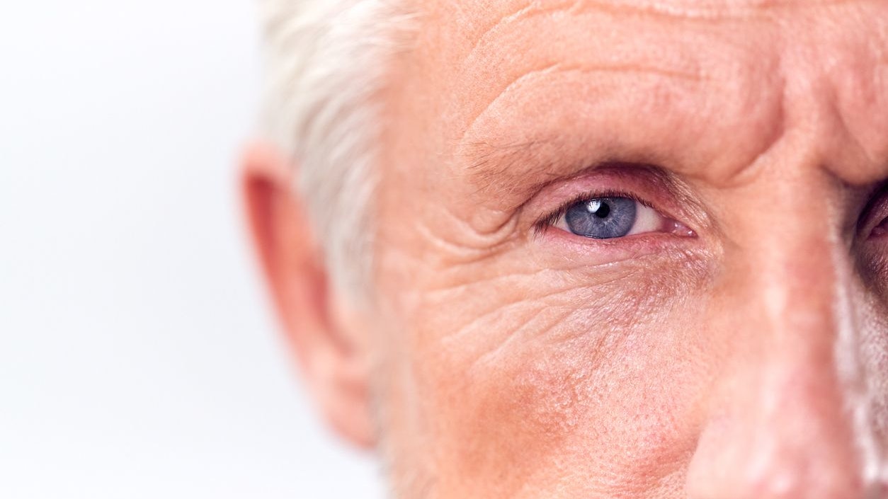 Studio Shot Of Mature Man With Serious Expression Cropped On Eyes Against White Background