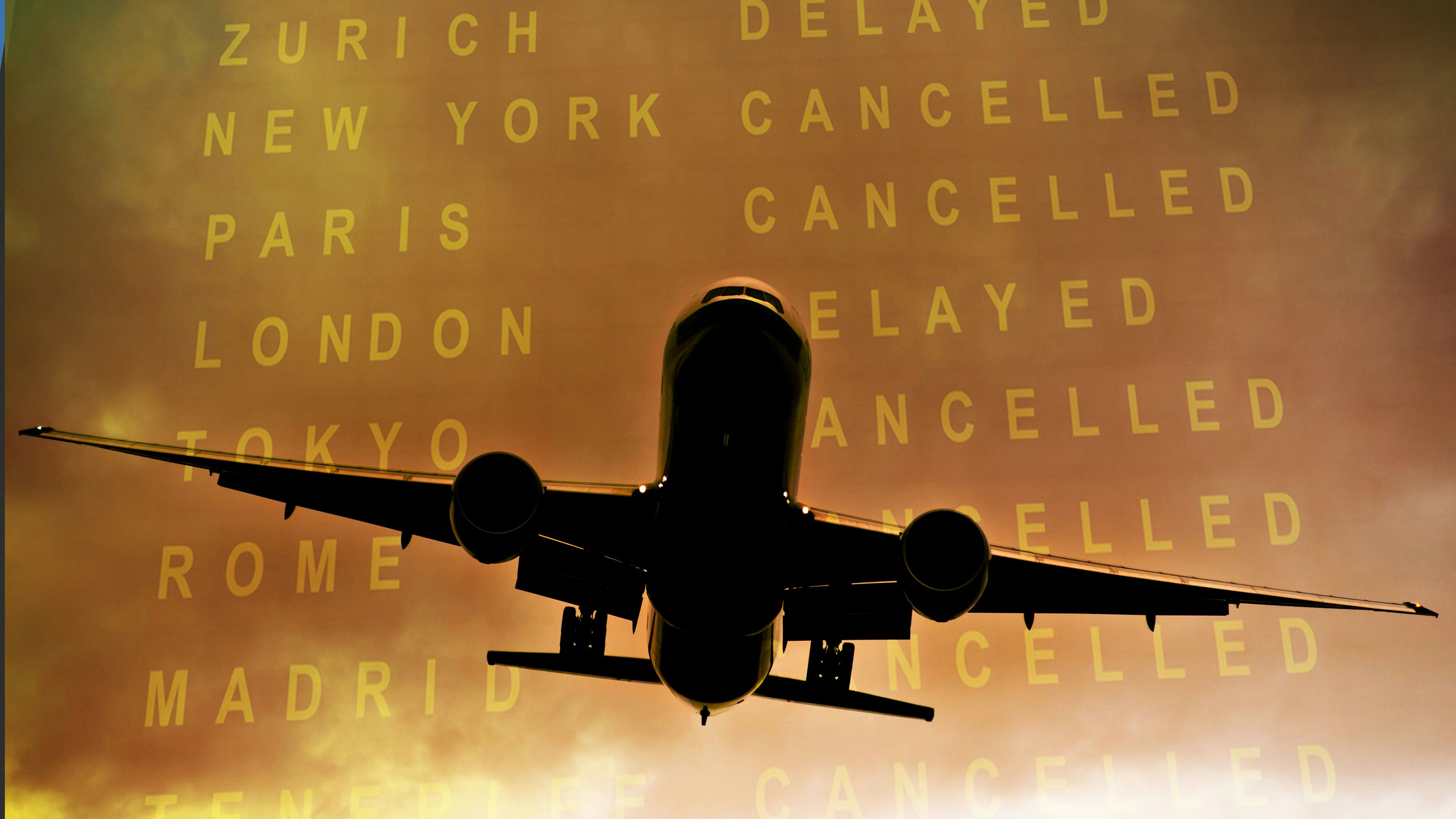 Commercial aircraft airborne against cloudy sky and timetable showing cancelled flights