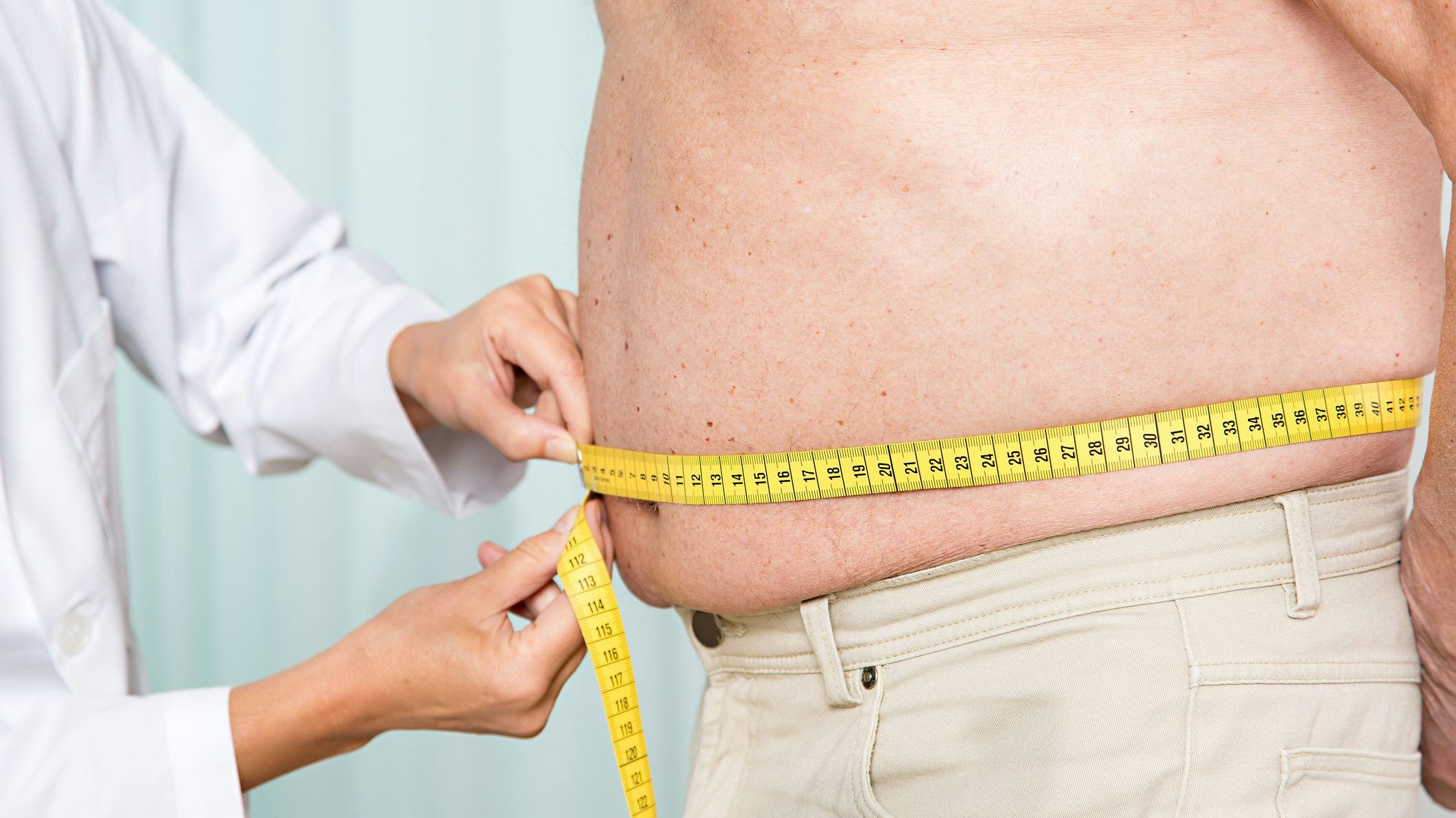 Medical examination: doctor measures overweight