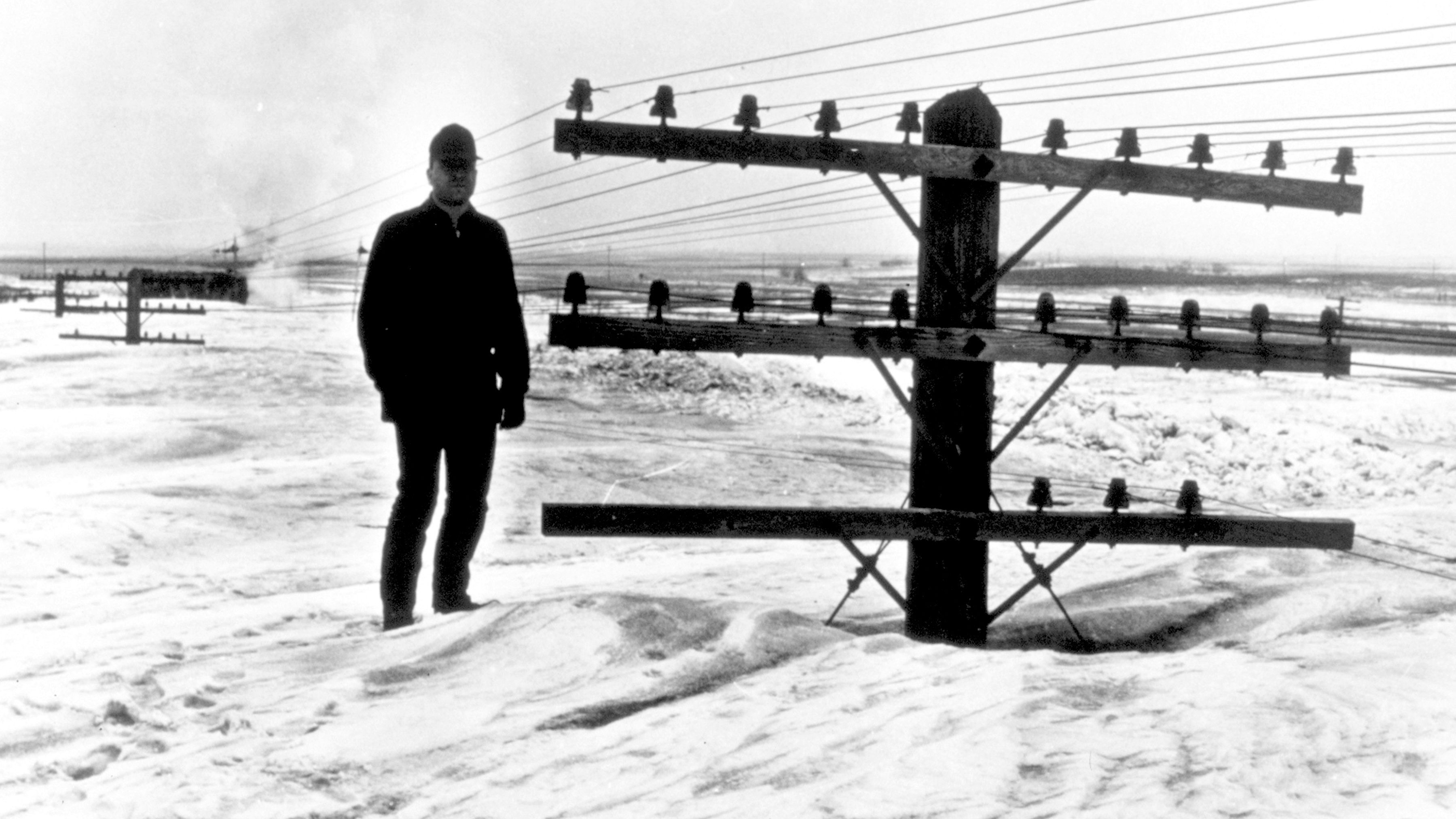 Standing tall on North Dakota snow. A March blizzard nearly buried utility poles. Caption jokingly read "I believe there is a train under here somewhere!" Jamestown, North Dakota March 9, 1966.