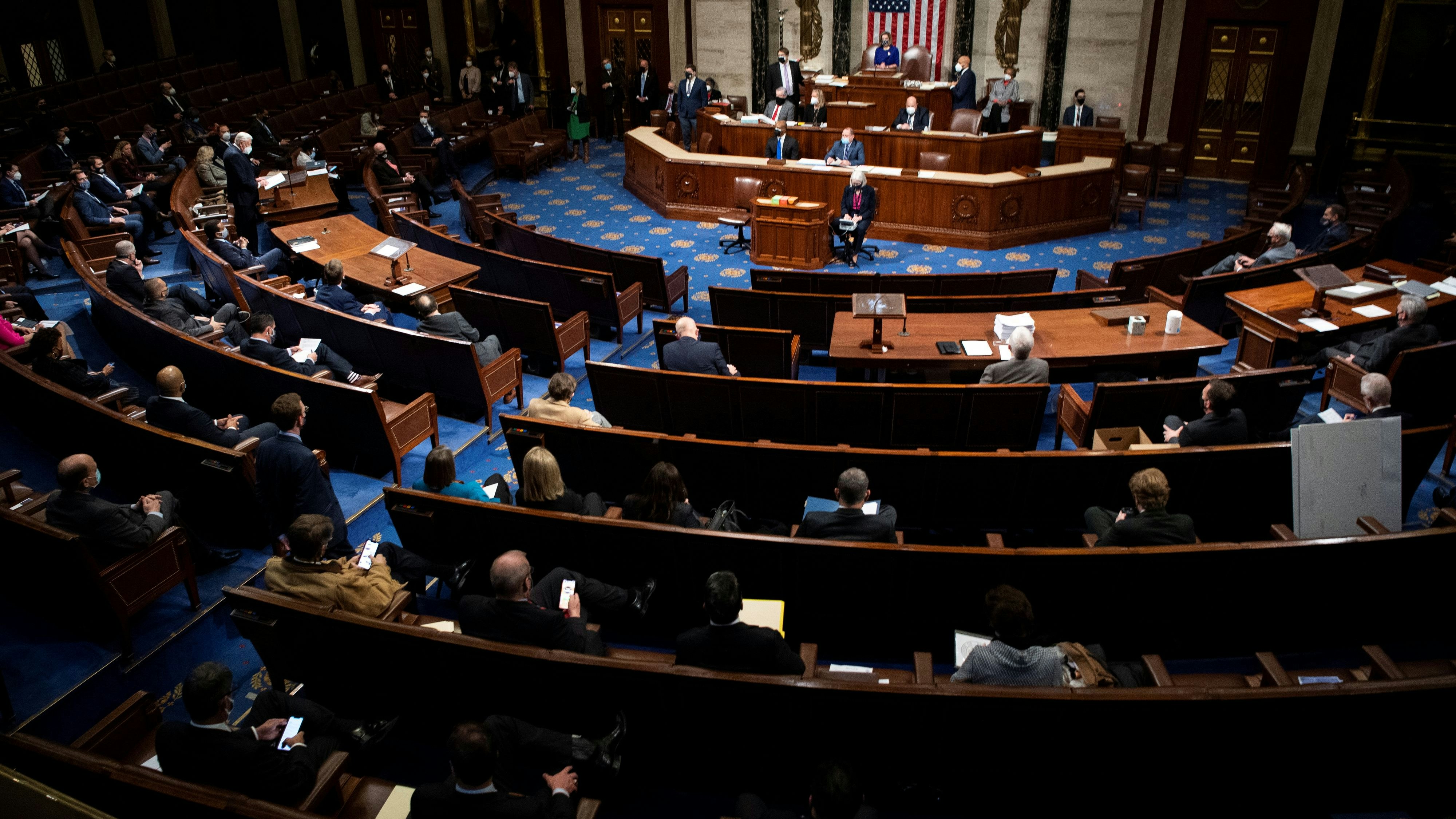 House members attend a reconvened joint session of Congress to certify the Electoral College votes of the 2020 presidential election in the House chamber in Washington, U.S., January 6, 2021. Caroline Brehman/Pool via REUTERS