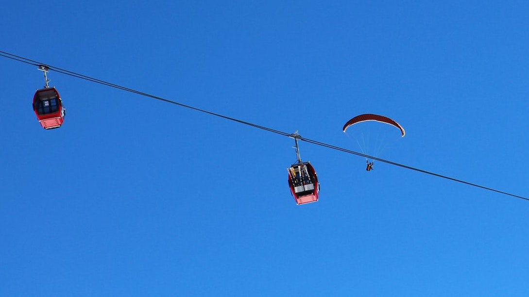 Paragliders and Gondola cable car at Westendorf from the top of the SkiWelt ski resort at mountain peak Choralpe (1.820 meter above sea) in Kitzbühler Alpen, Austria