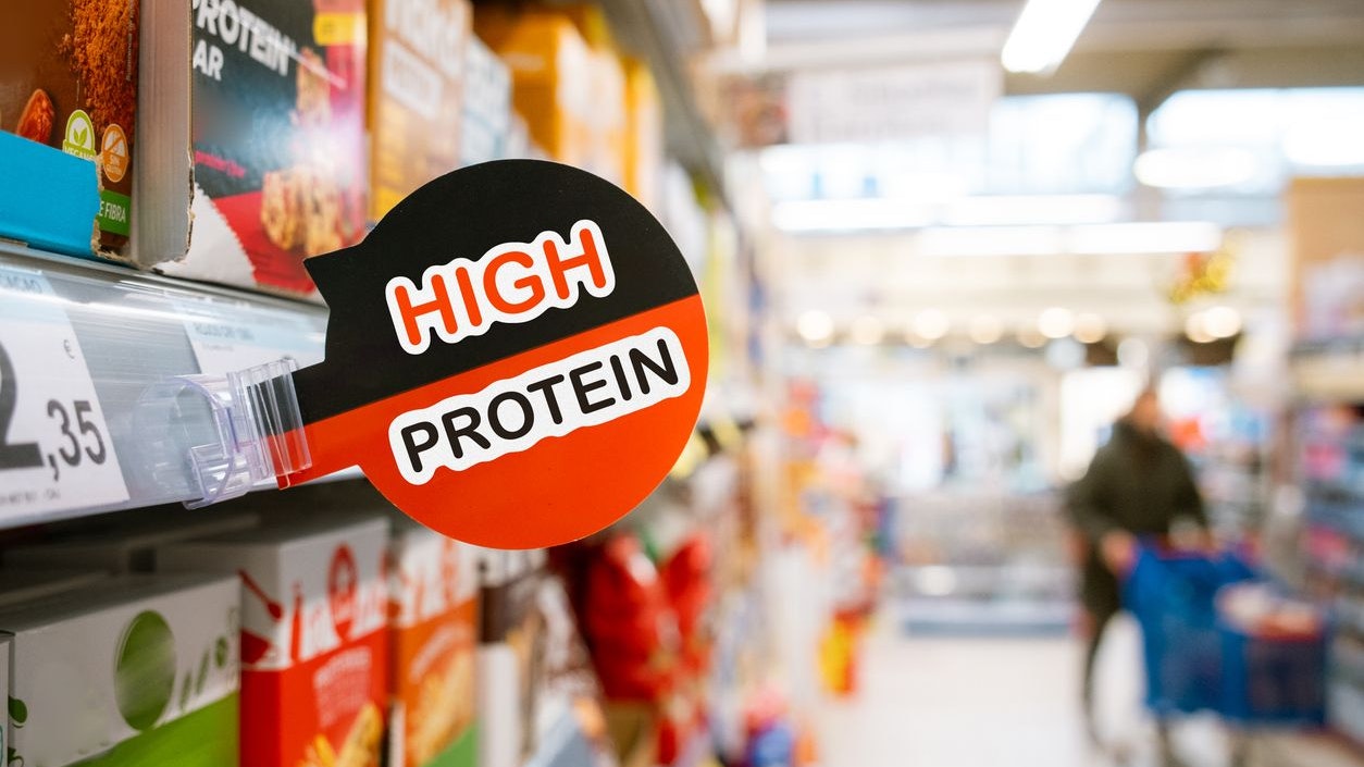 A high protein sign in a supermarket aisle