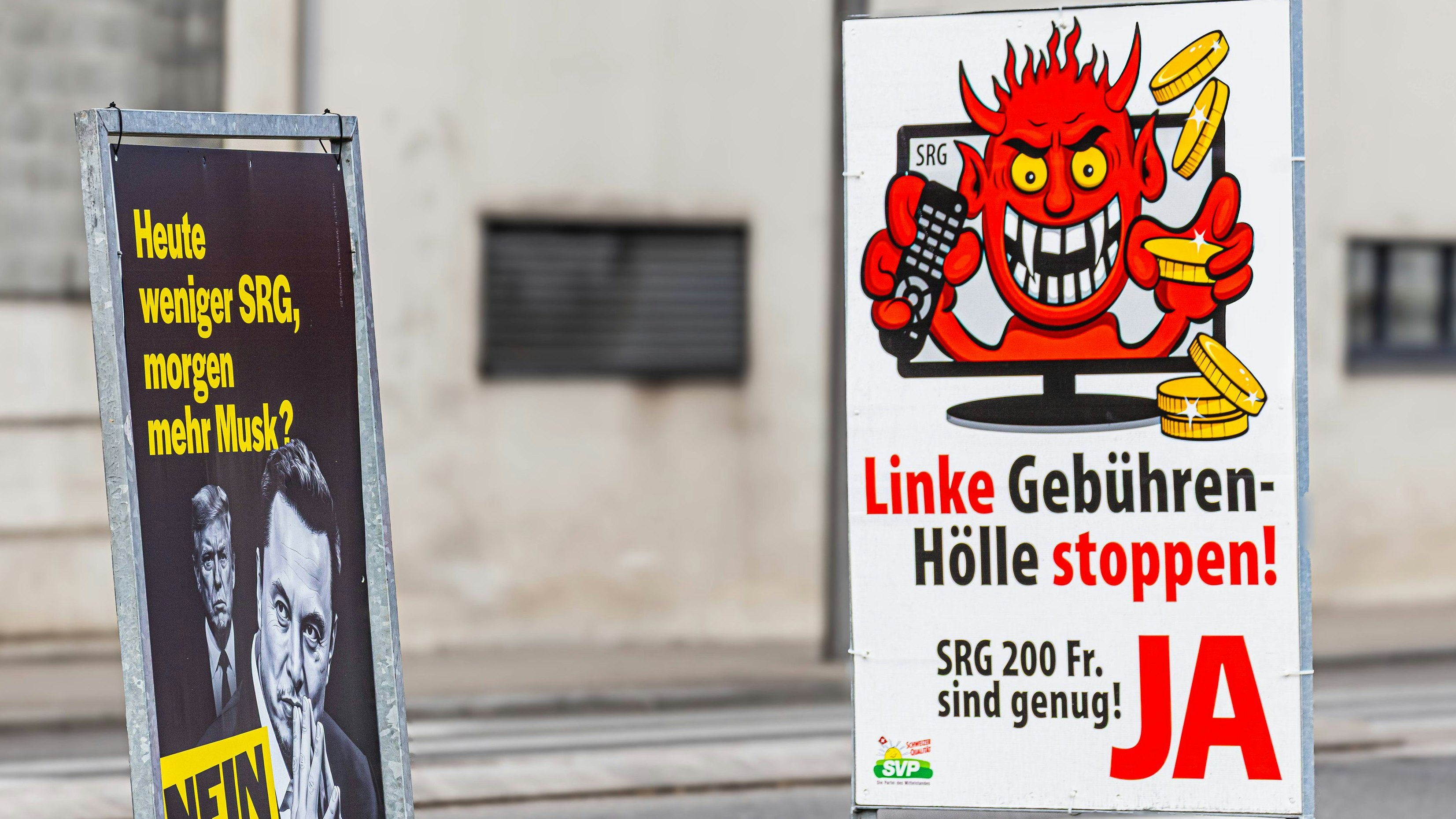 Voting poster for the SRG halving initiative Schaffhausen, Switzerland, 1st Mar 2026: On the left is a political campaign poster against halving the broadcasting fees. It features Elon Musk and Donald Trump. The poster is from the Social Democratic Party of Switzerland. Next to it is a campaign poster in favor of halving the broadcasting fees, from the Swiss People s Party. Photo by Andreas Haas/dieBildmanufaktur *** Voting poster for the SRG halving initiative Schaffhausen, Switzerland, 1st Mar 2026 On the left is a political campaign poster against halving the broadcasting fees It features Elon Musk and Donald Trump The poster is from the Social Democratic Party of Switzerland Next to it is a campaign poster in favor of halving the broa