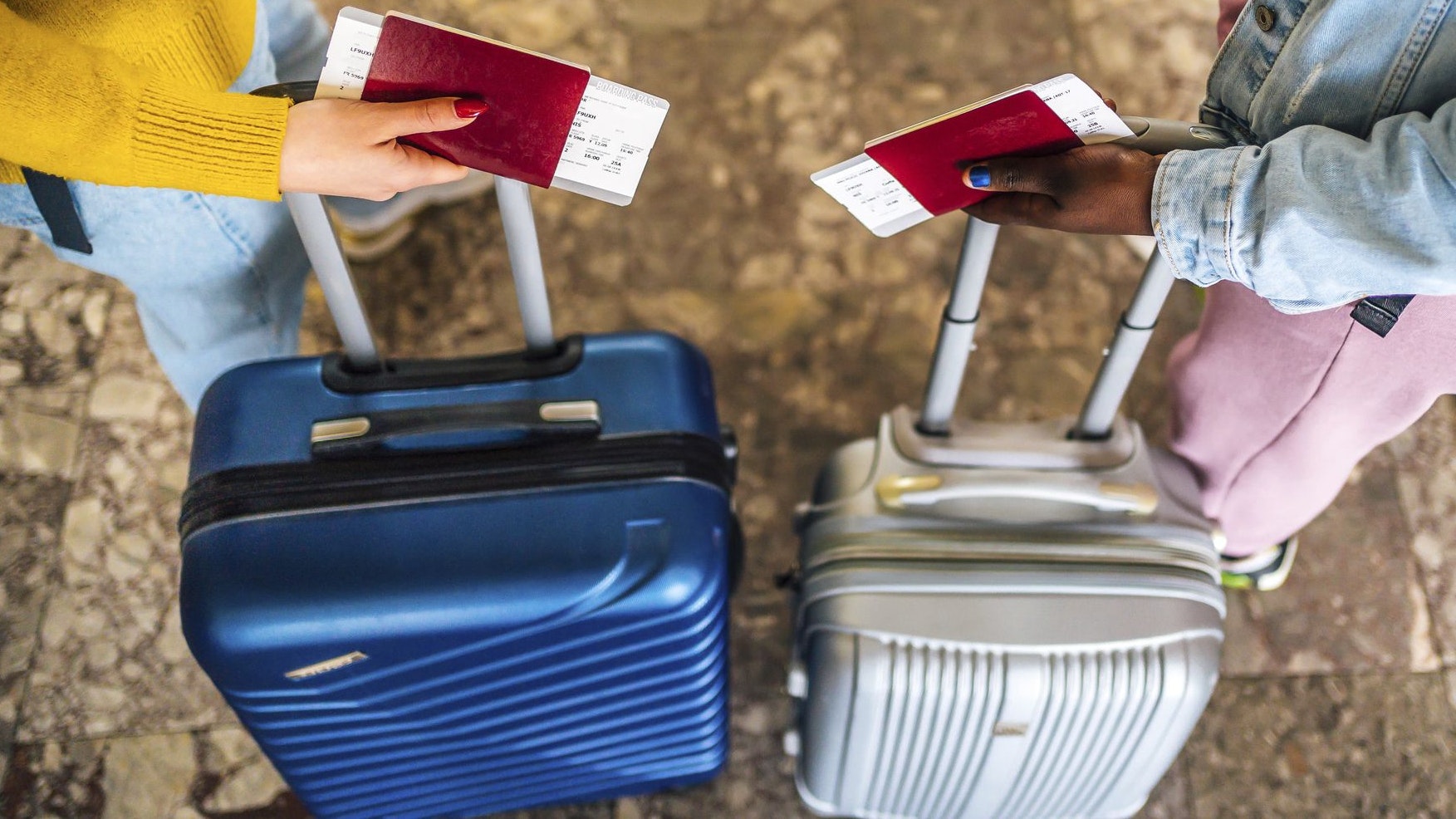 Multi racial women friends with passports and luggage bags  on airport