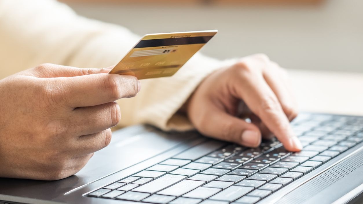 A person using laptop input data for credit card online payment service. Cashless payment using laptop online application and make money transfer completely via internet.