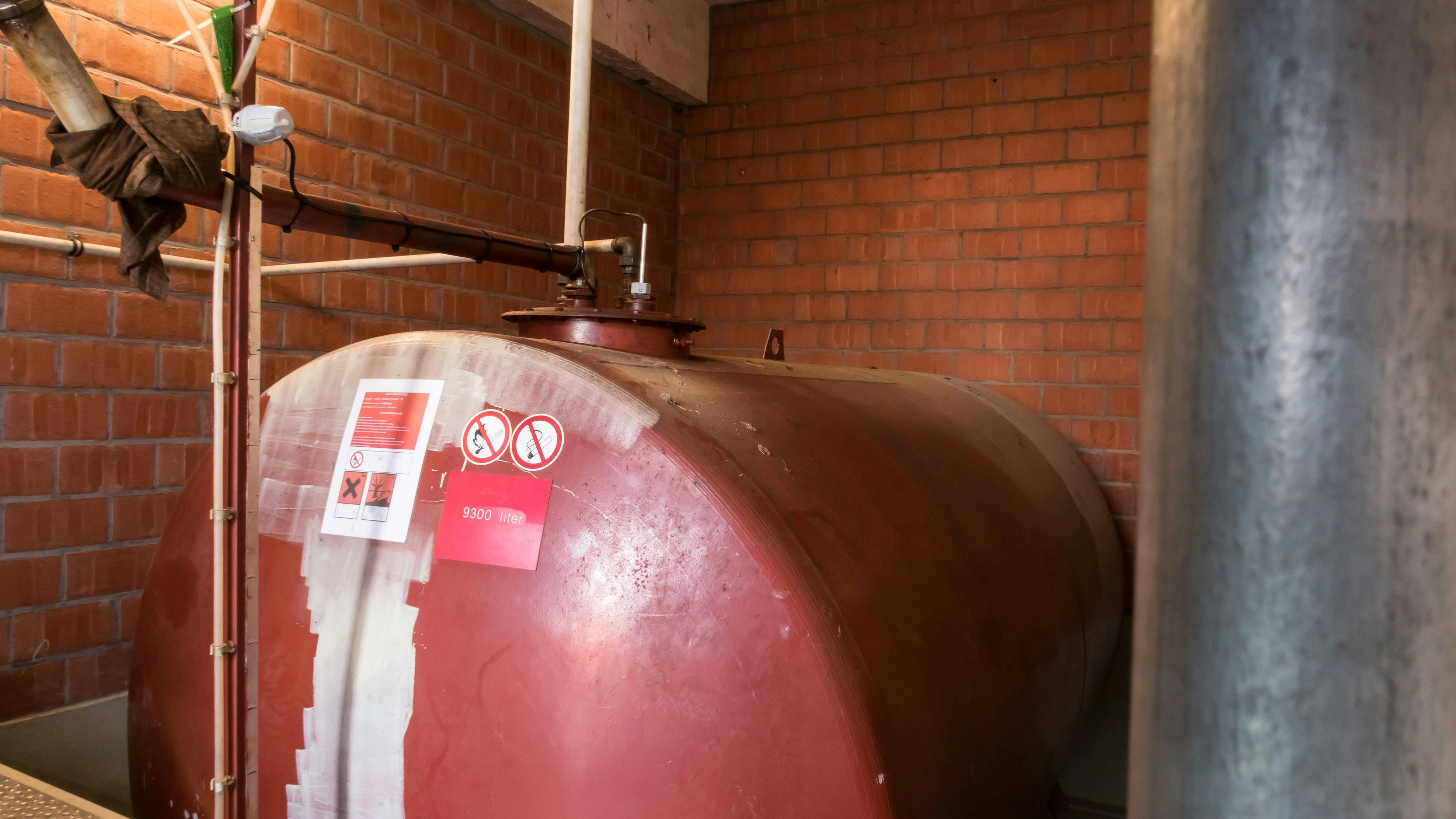 in a separate room in a old building, there is a heating oil tank