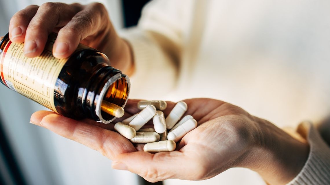 Woman taking vitamin pills