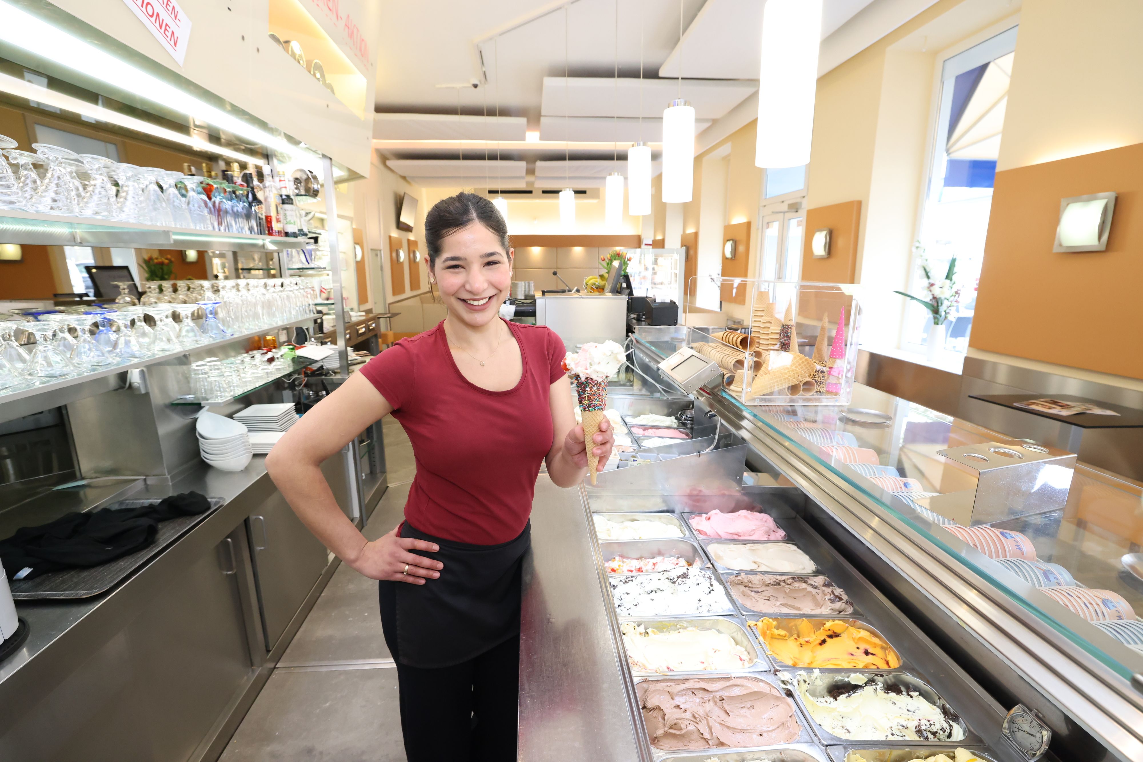 Verkäuferin Viki vom Eissalon Mauß mit einer Tüte Cassata spezial, Torrone und Erdbeer-Rahm.