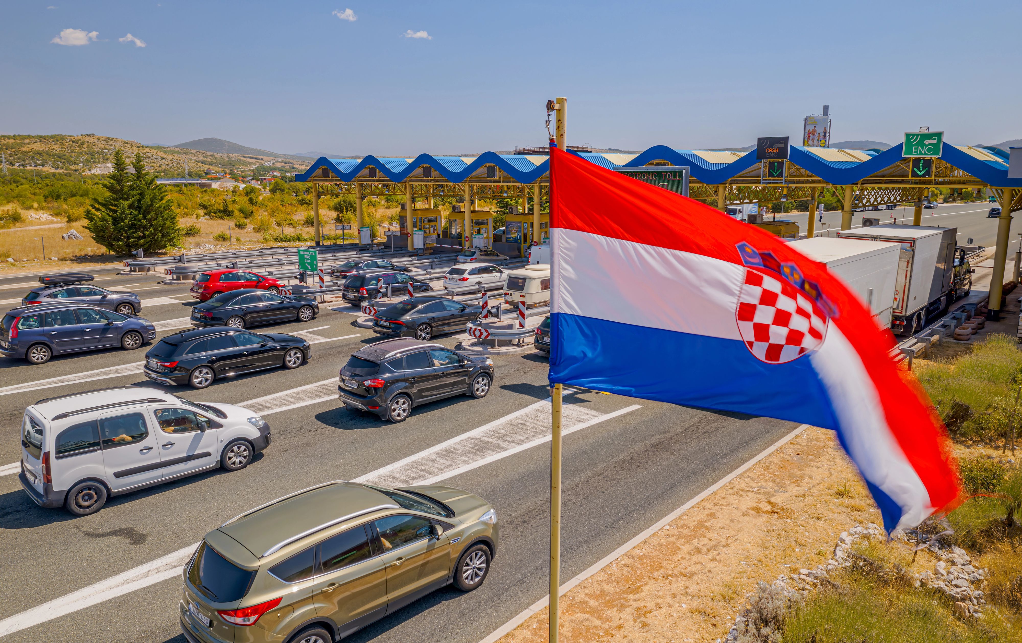 SPLIT, CROATIA - August 12 2021: Aerial view of the traffic waiting at toll booths in Dugopolje in summer time.