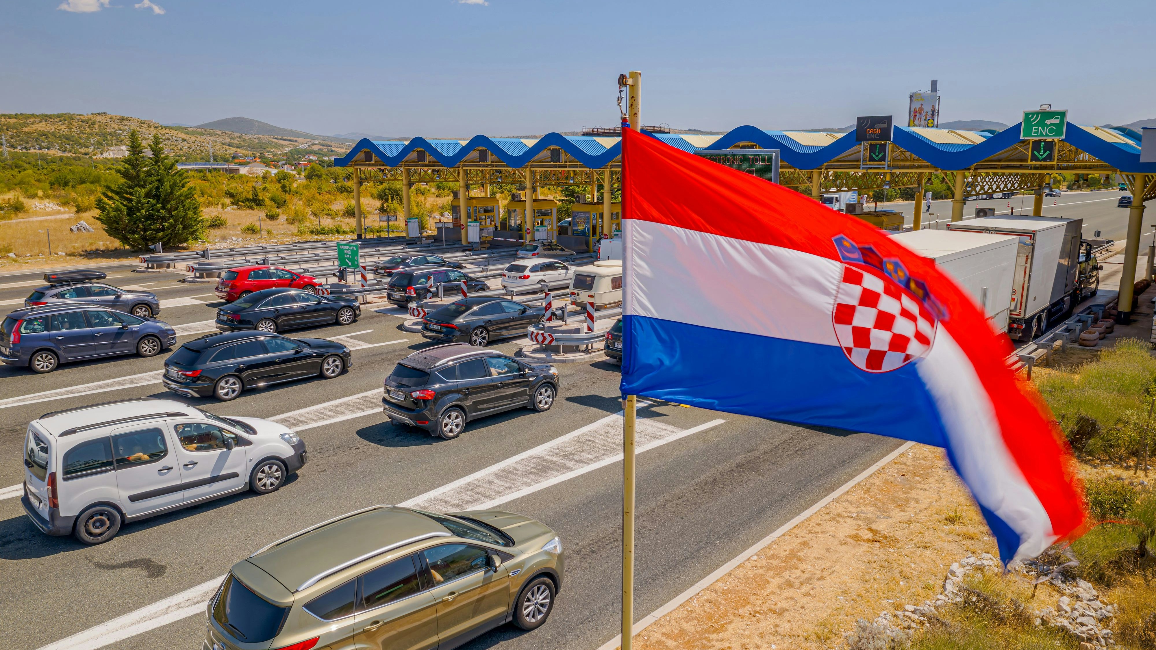 SPLIT, CROATIA - August 12 2021: Aerial view of the traffic waiting at toll booths in Dugopolje in summer time.