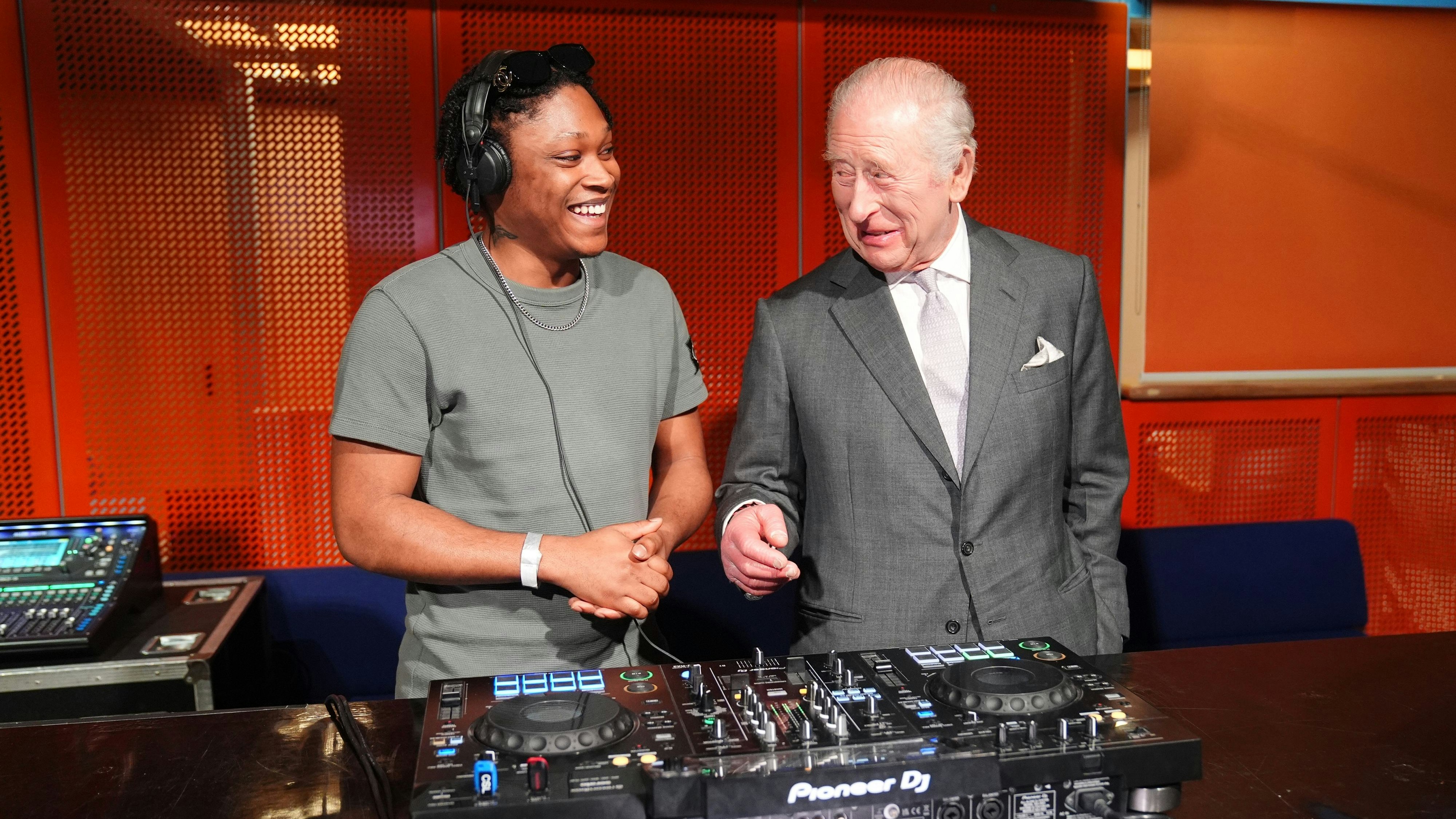King Charles III talks to Christian St Louis during a visit to Aviva Studios, in Manchester, the home of Factory International, to see the collaboration between the King's Trust and Factory Academy, who deliver the Trust's Creative Futures, Get into Event Production programme. Picture date: Monday March 16, 2026.