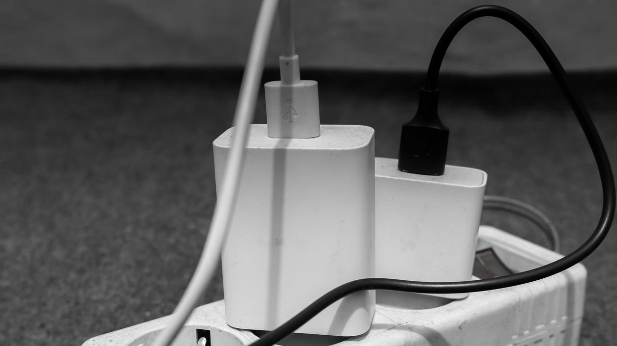 Two smart phone chargers plugged into the electrical terminals.