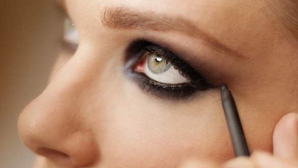 "A model getting her make-up, shallow depth of field, added grain."