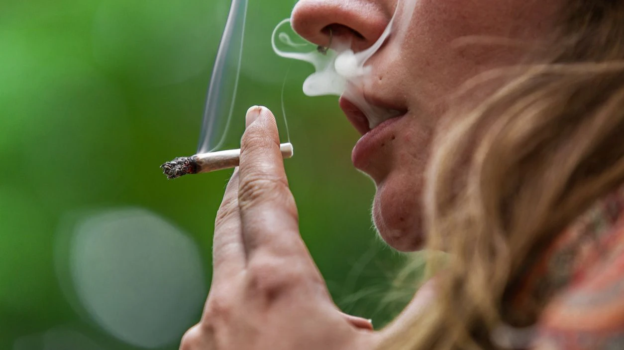 Close-Up Of Woman Smoking Weed Outdoors