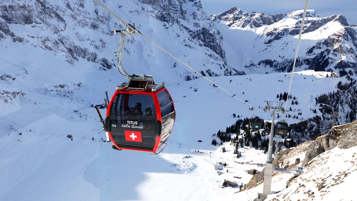 Engelberg, Switzerland - February 11, 2016: Titlis gondola with Swiss flag in Engelberg Switzerland. Mount Titlis (10,000 ft) is the highest glacier excursion destination and biggest ski and snowboard paradise in Central Switzerland attracting many skiers and tourists from all over the world.
