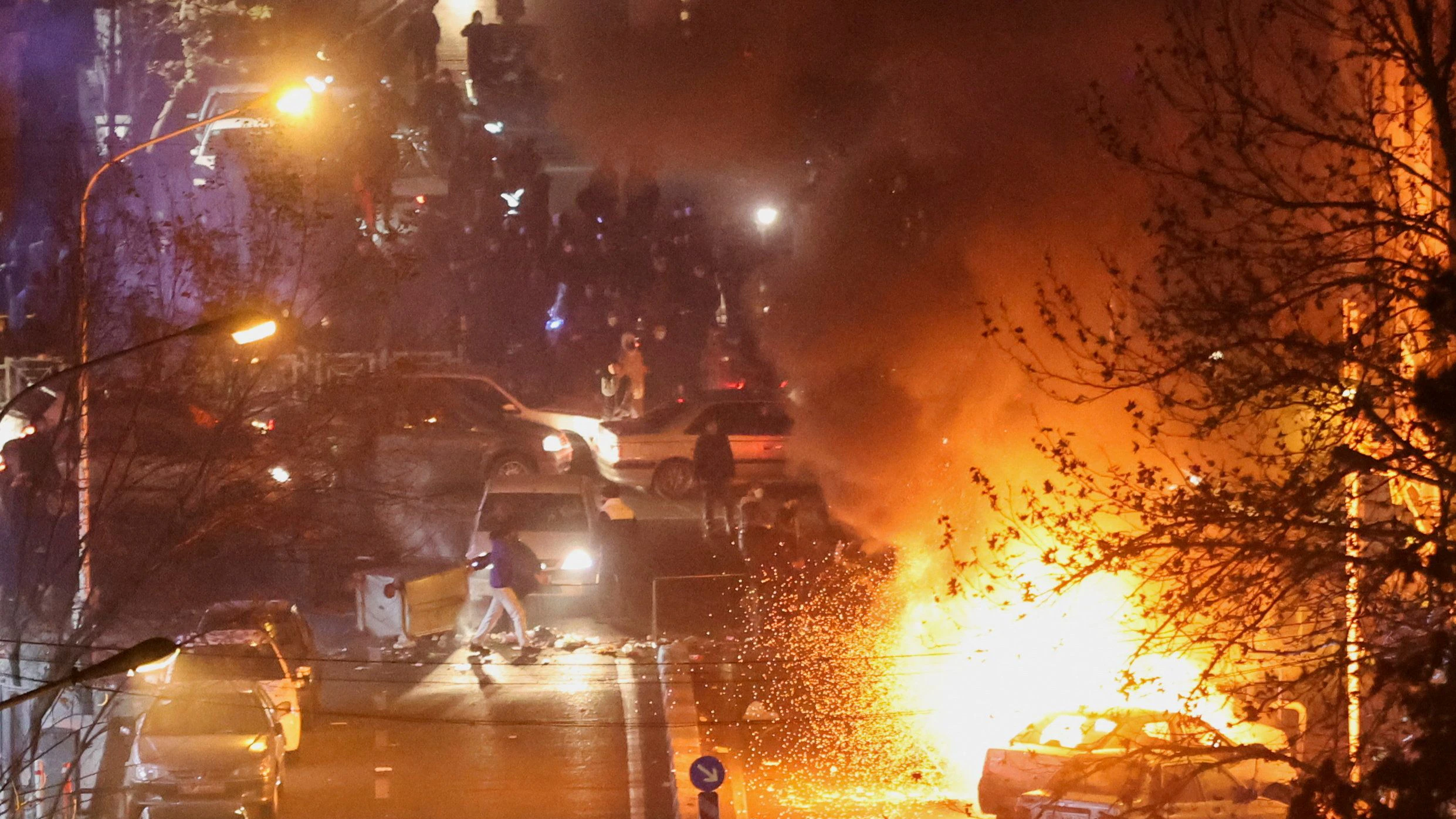 Cars burn in a street during a protest over the collapse of the currency's value, in Tehran, Iran, January 8, 2026. Stringer/WANA (West Asia News Agency) via REUTERS ATTENTION EDITORS - THIS PICTURE WAS PROVIDED BY A THIRD PARTY