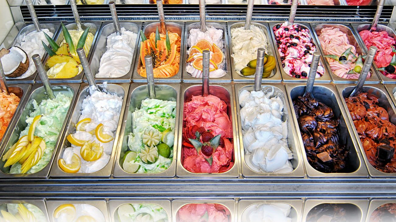 Display of assorted ice creams in metal tubs in a shop or ice cream parlour