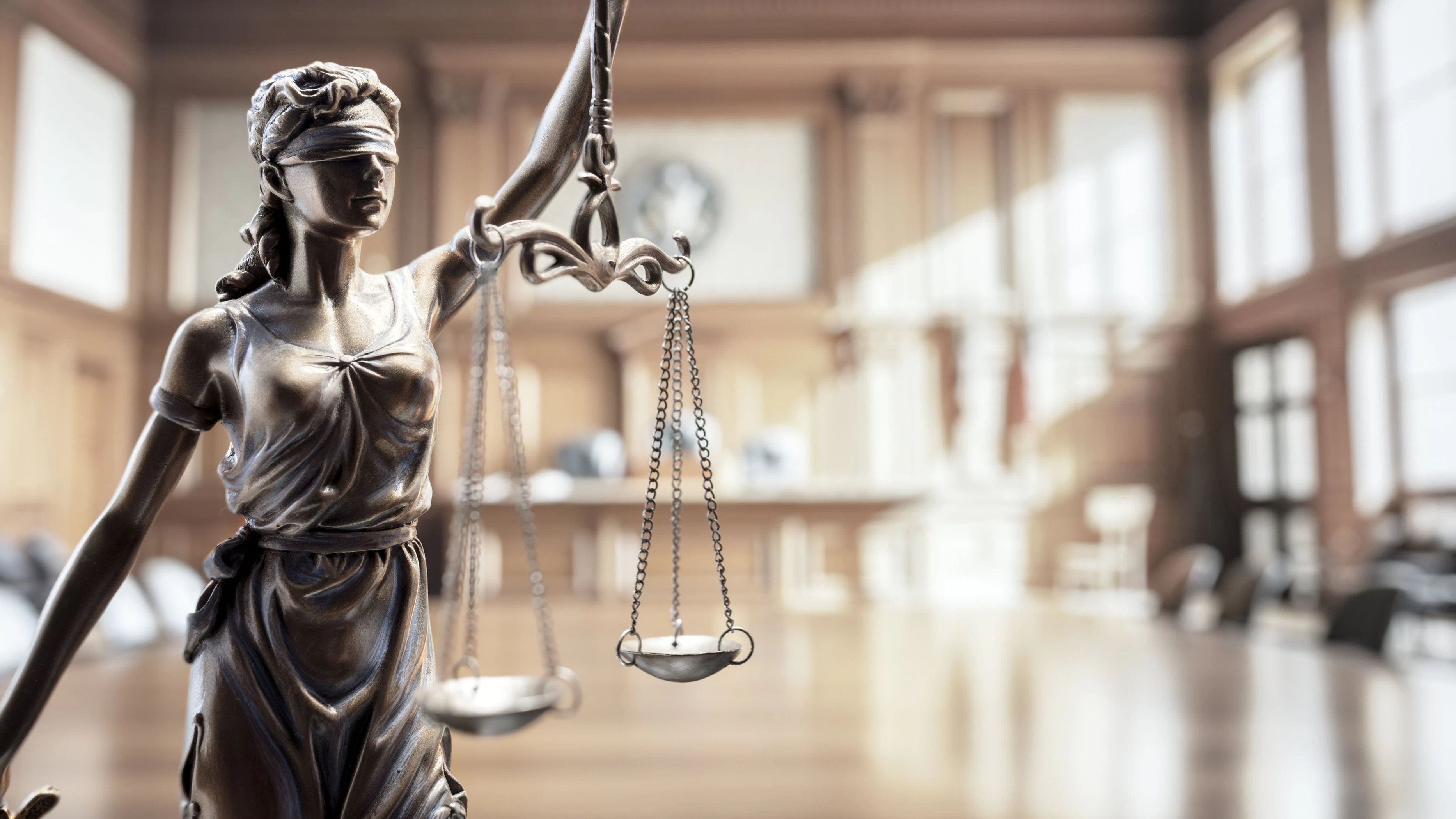 Legal and law concept statue of Lady Justice with scales of justice in court room background