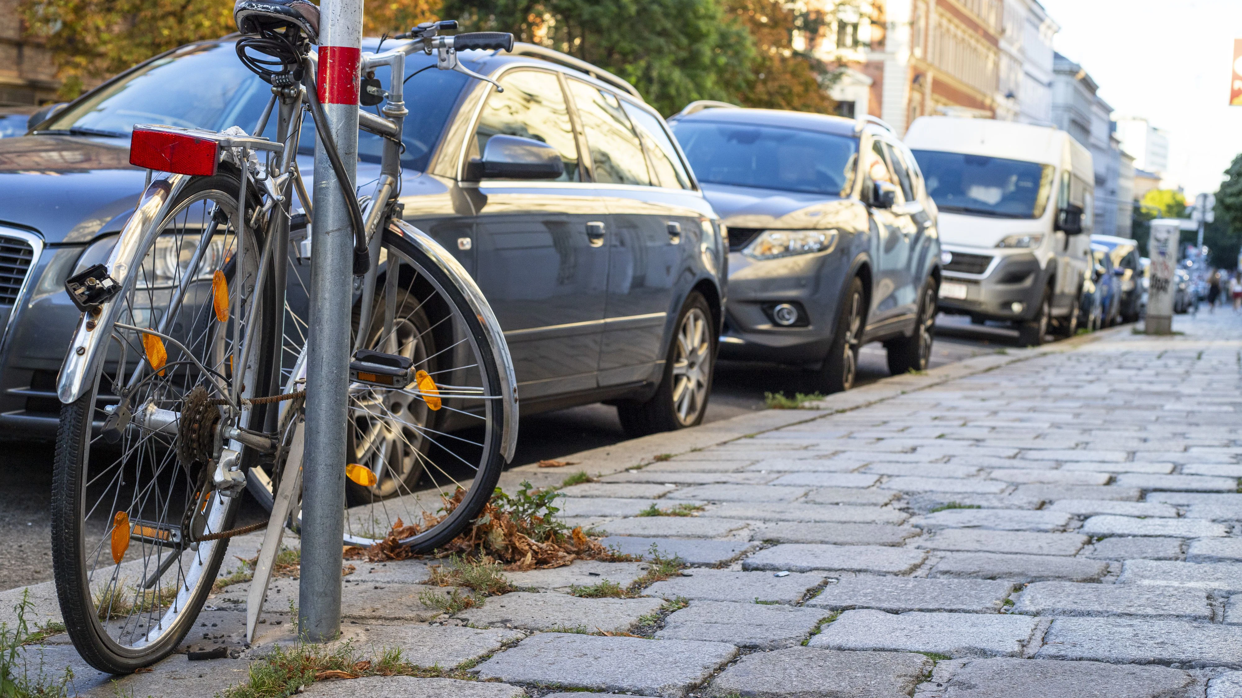 In Wien zählen Straßen mit vielen parkenden Autos, Fahrräderabstellplätze und Fahrradwege zum gängigen Stadtbild. Zuletzt wurde eine Preiserhöhung für den öffentlichen Verkehr sowie eine Erhöhung der Gebühr für parkende Autos und Dauerparkkarten seitens der österreichischen Regierung beschlossen. Im Bild: Blick auf eine Straße mit parkenden Autos und ein Fahrrad, aufgenommen am 01. September 2025 im 09. Bezirk in Wien. // In Vienna, streets with many parked cars, bicycle parking spaces, and bike lanes are part of the typical cityscape. Most recently, the Austrian government decided on a price increase for public transportation as well as a rise in fees for parked cars and long-term parking permits. In the picture: A view of a street with parked cars and a bicycle, taken on September 1st, 2025, in Vienna's 9th district.