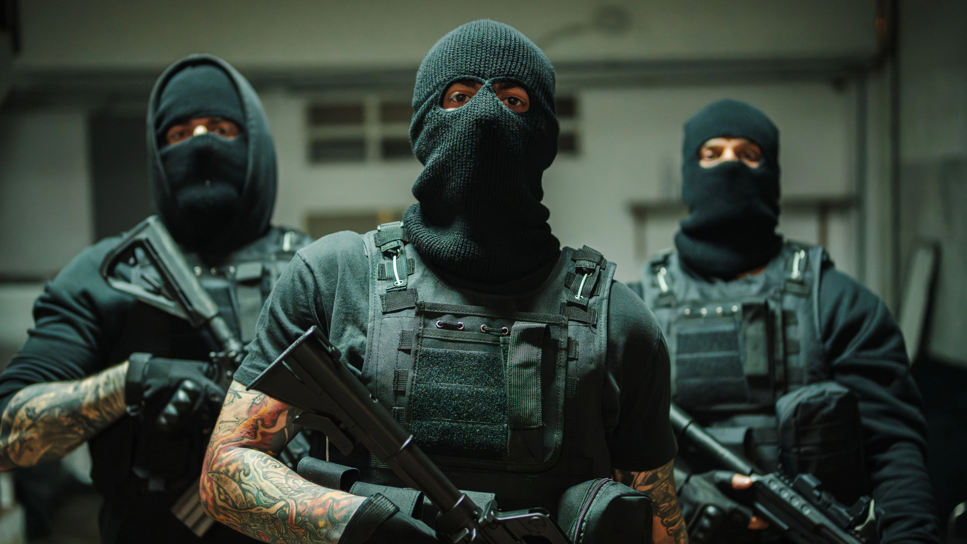 Dynamic representation of a skilled team of armed operatives prepared for action, exuding confidence and strength while wielding their firearms in a tactical display of professionalism