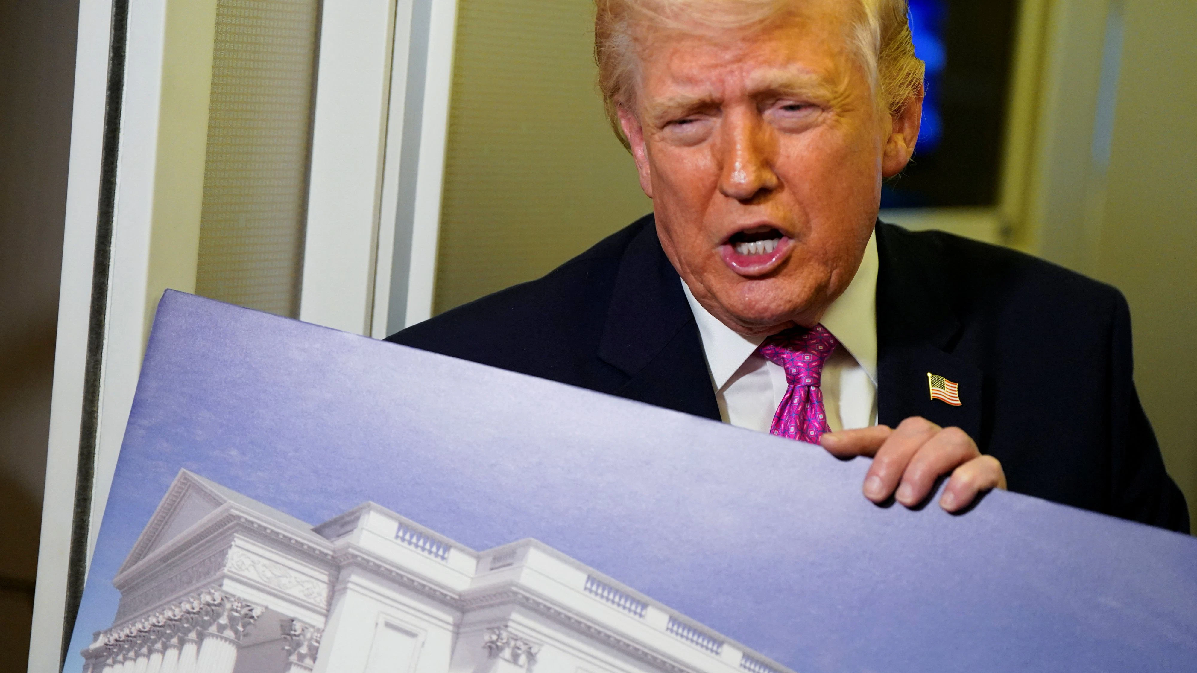 U.S. President Donald Trump talks to members of the media while holding up renderings of the planned White House ballroom, aboard Air Force One en route to Joint Base Andrews, Maryland, U.S., March 29, 2026. REUTERS/Elizabeth Frantz