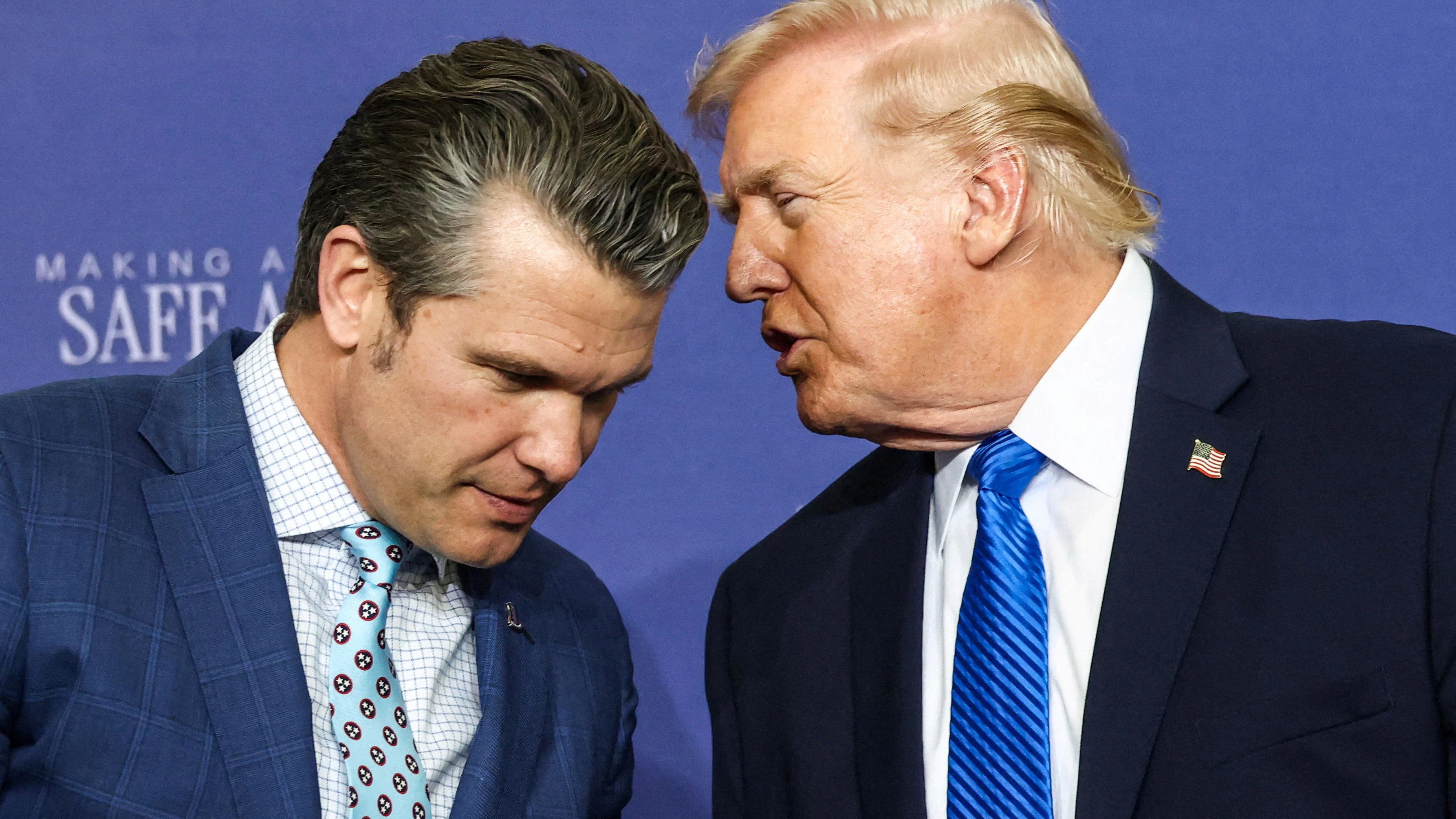 U.S. President Donald Trump speaks with U.S. Defense Secretary Pete Hegseth at Memphis Air National Guard Base in Memphis, Tennessee, U.S., March 23, 2026. REUTERS/Kevin Lamarque       TPX IMAGES OF THE DAY     